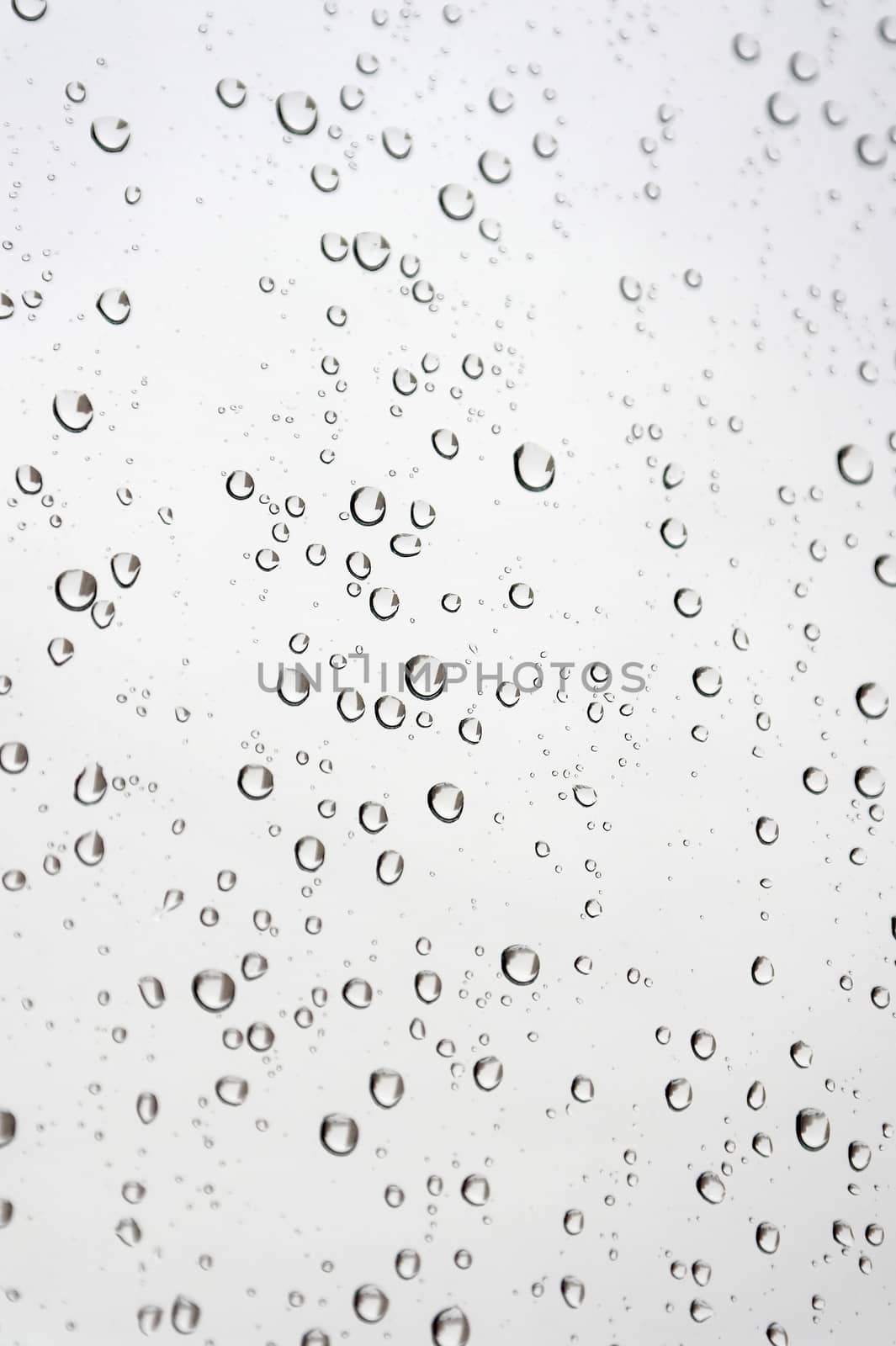 Drops of rain on the inclined window, shallow dof