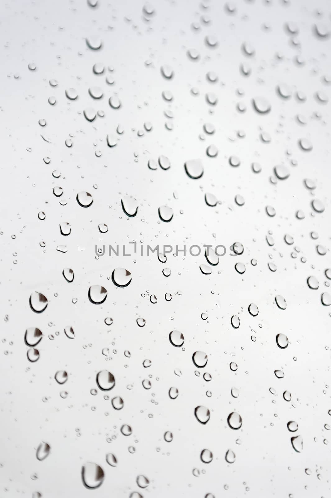 Drops of rain on the inclined window, shallow dof