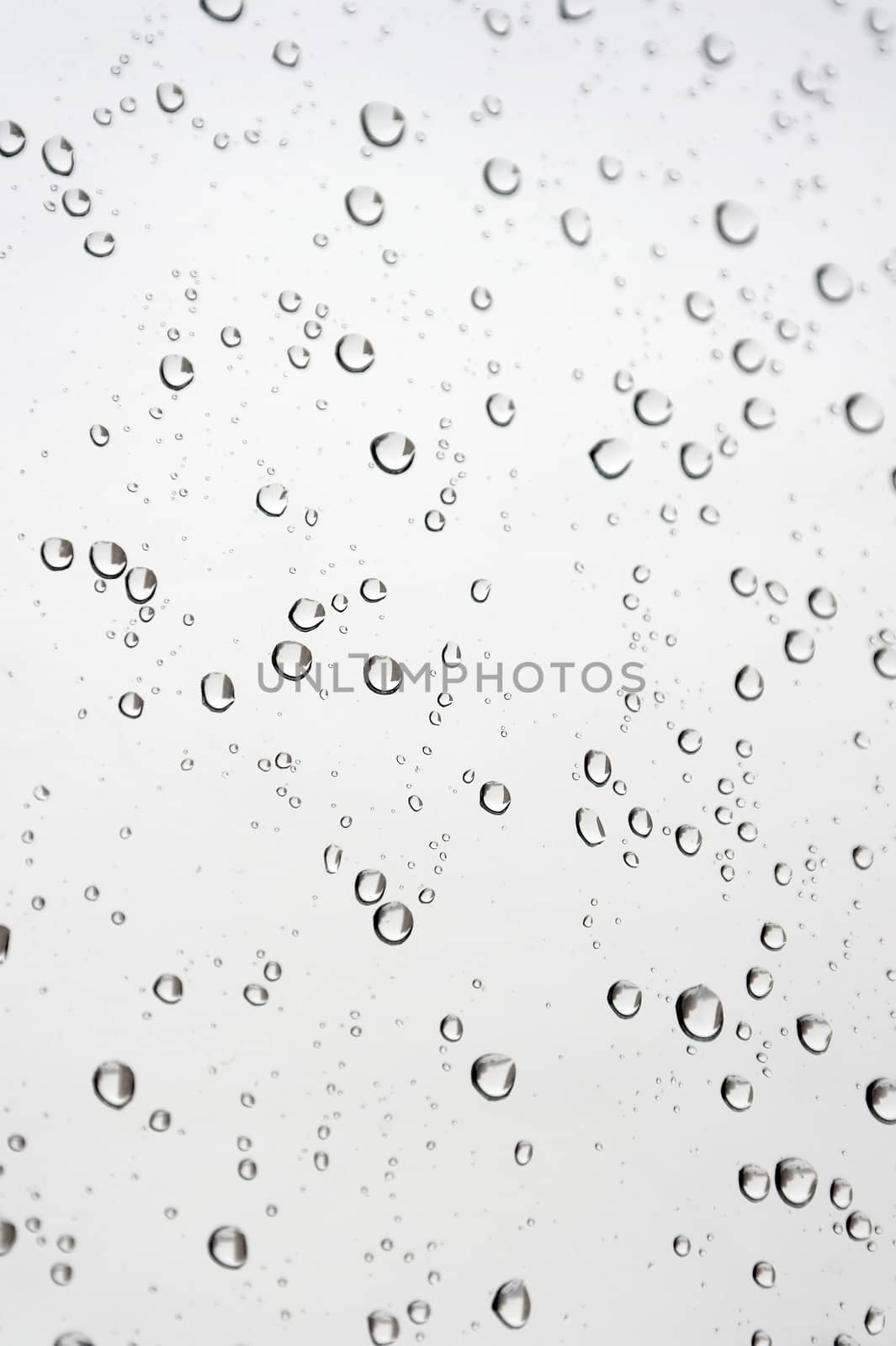 Drops of rain on the inclined window, shallow dof