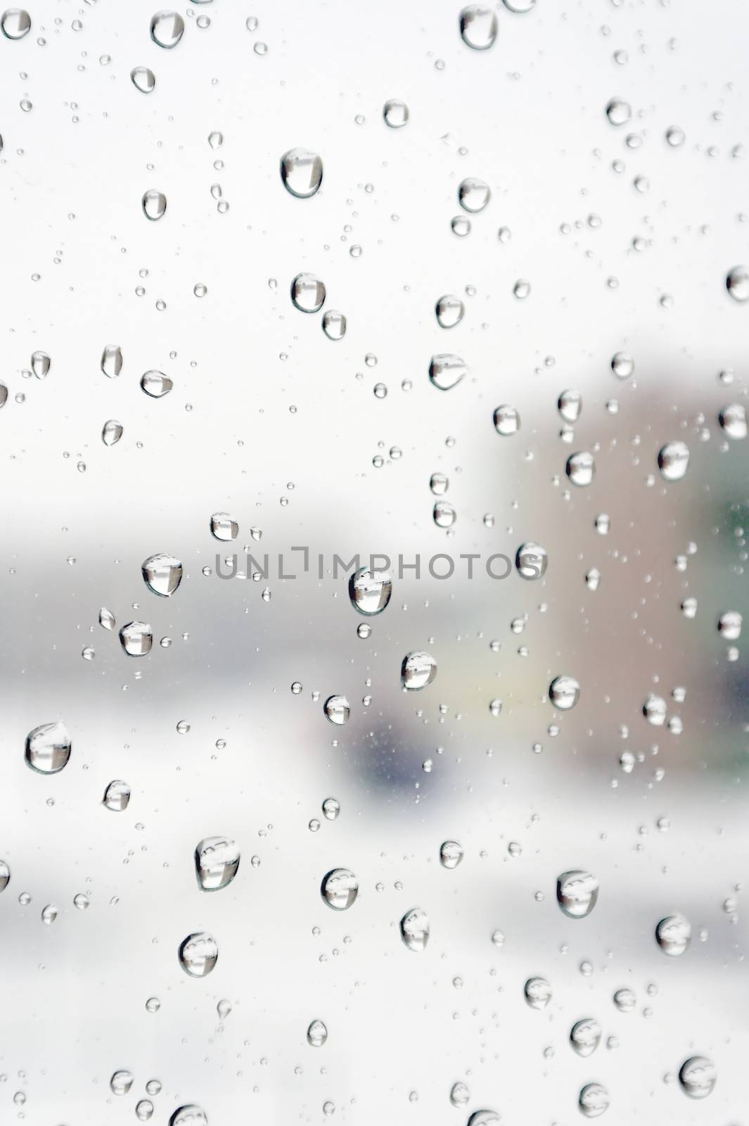 On a winter raining day. Drops of water on the window. Shallow DOF