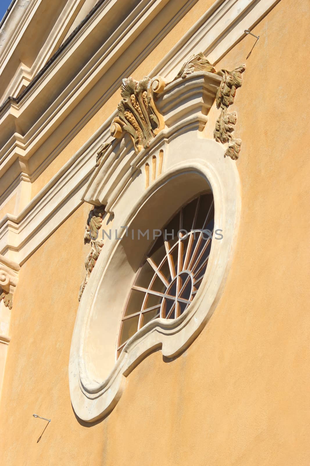 Circle Window on the yellow wall of the Church of Eze, France