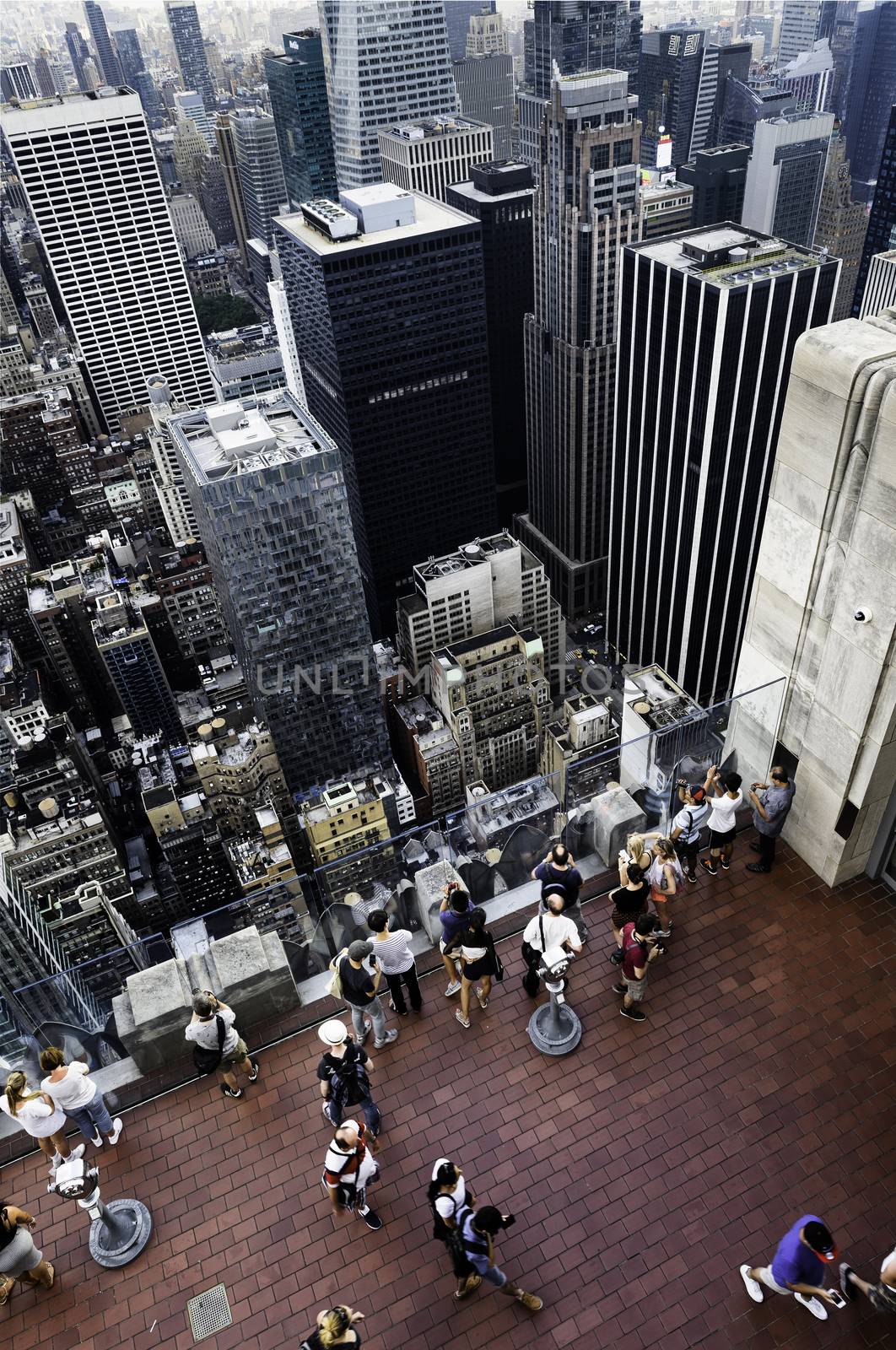 NEW YORK CITY -JULY 11: Skyline and times Square, featured with tourist people on a roof, is a symbol of New York City and the United States, July 11, 2015 in Manhattan, New York City. USA.