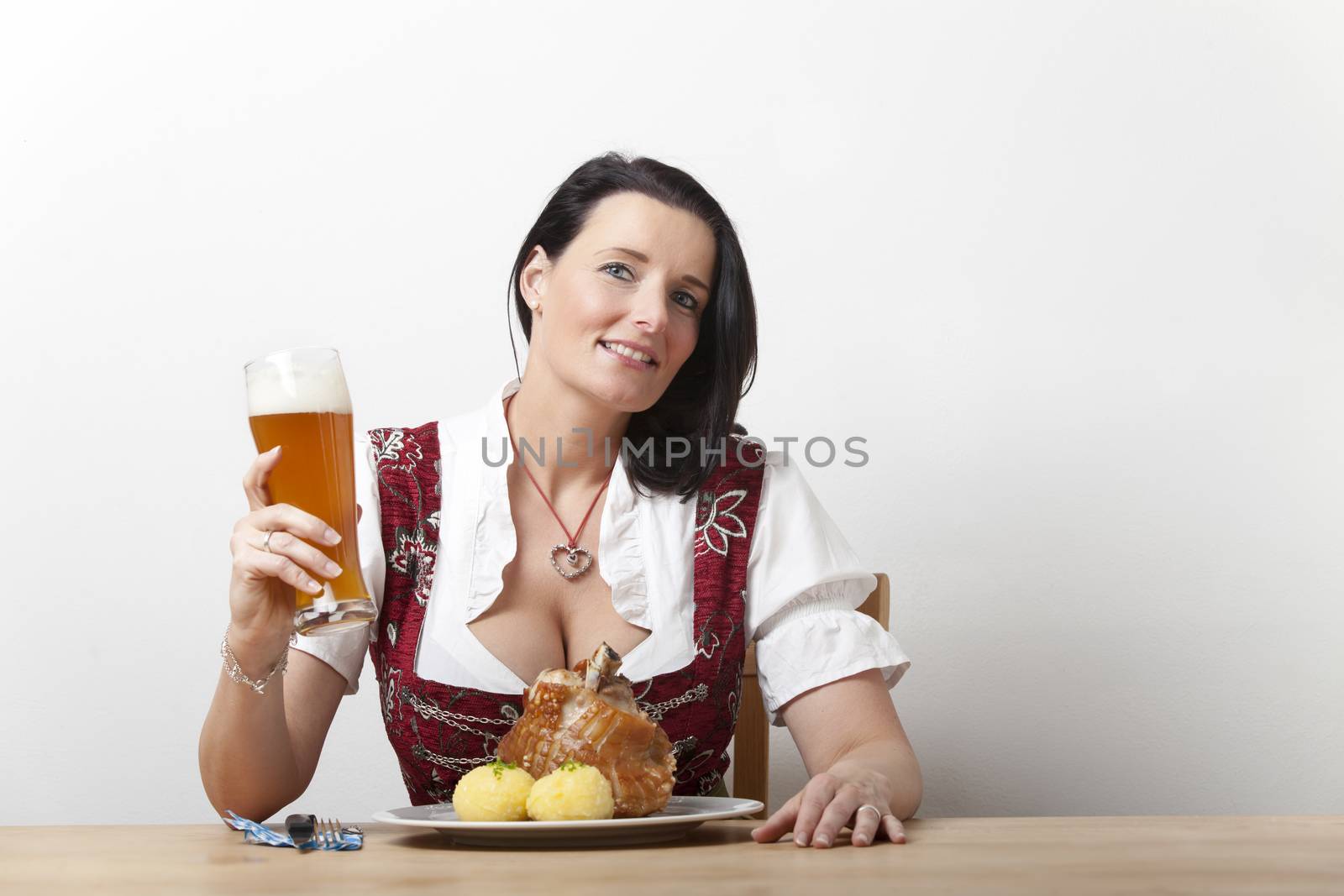 bavarian woman in a dirndl with pork by bernjuer