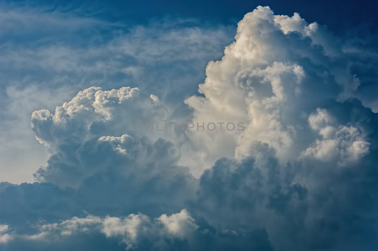 Large fluffy cloud relief details on blue sky