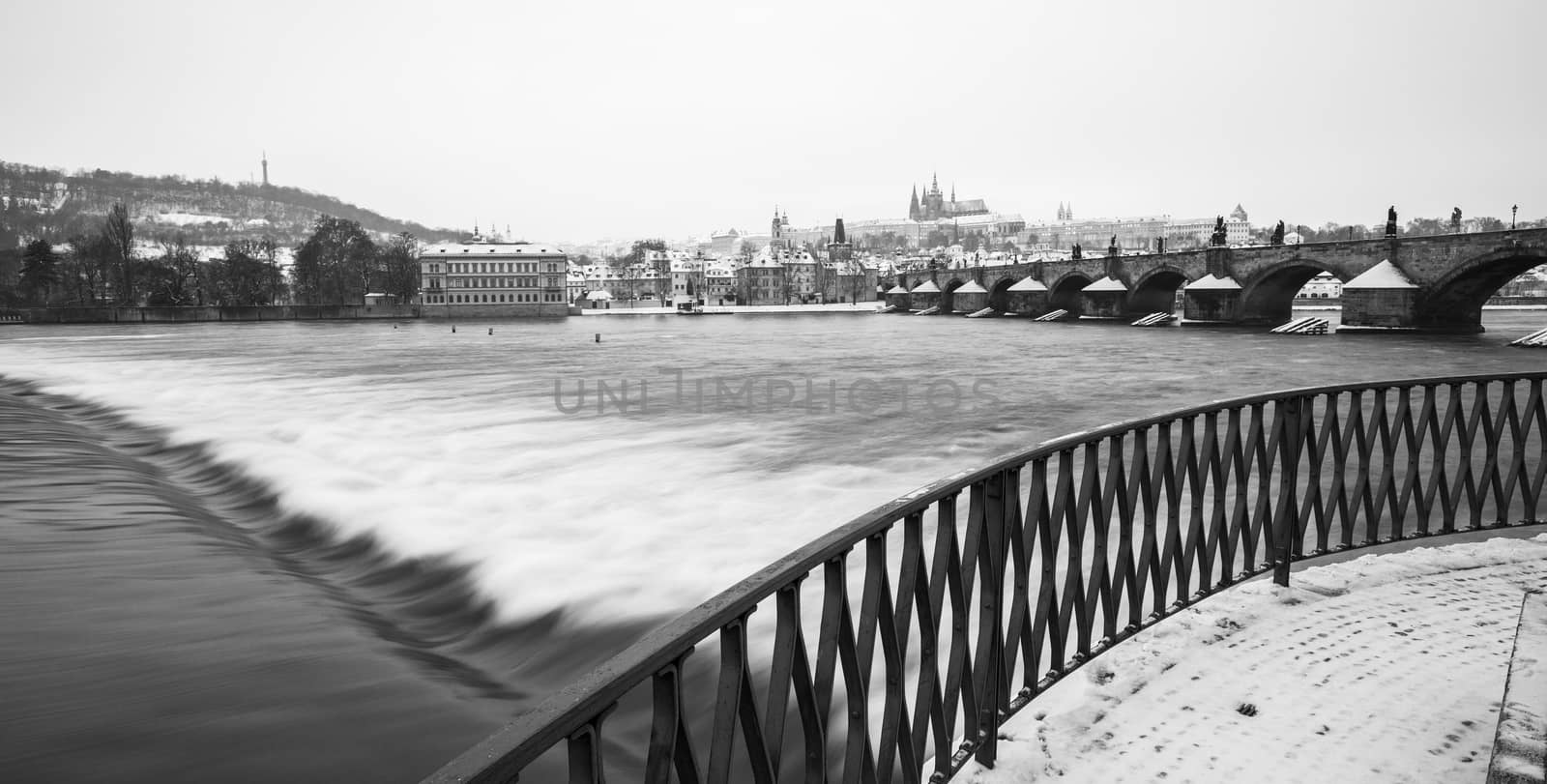 Romantic Snowy Prague gothic Castle with the Charles Bridge, Czech Republic