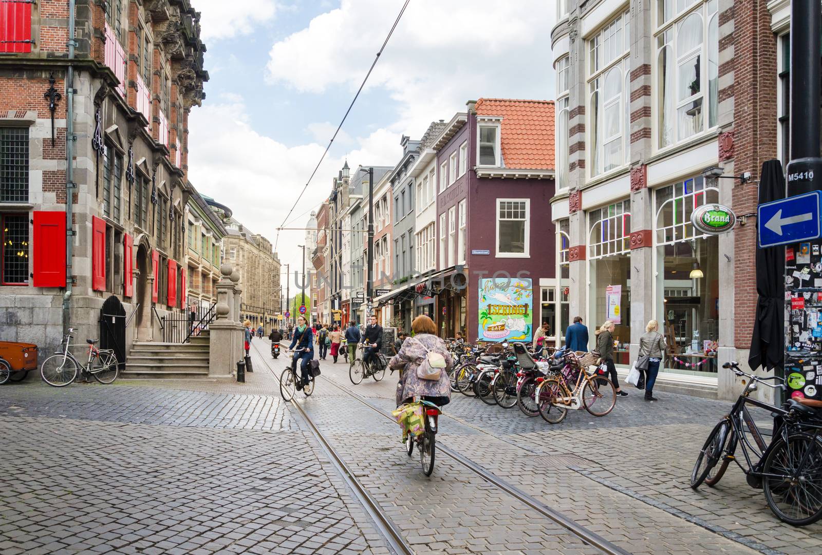 The Hague, Netherlands - May 8, 2015: People shopping on venestraat shopping street in The Hague, Netherlands. on  May 8, 2015. The Hague is the capital city of the province of South Netherlands. With a population of 515,880 inhabitants.