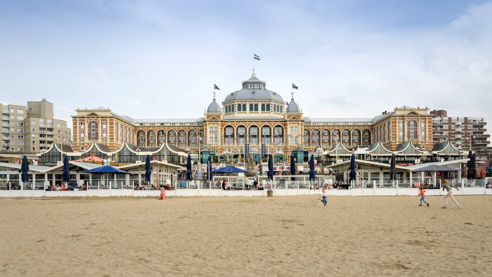 The Hague, Netherlands - May 8, 2015: Tourists at Kurhaus of Scheveningen, The Hague in the Netherlands is a hotel which is called the "Grand Hotel Amrath Kurhaus The Hague" since October 2014. It is located in the main seaside resort area, near the beach.