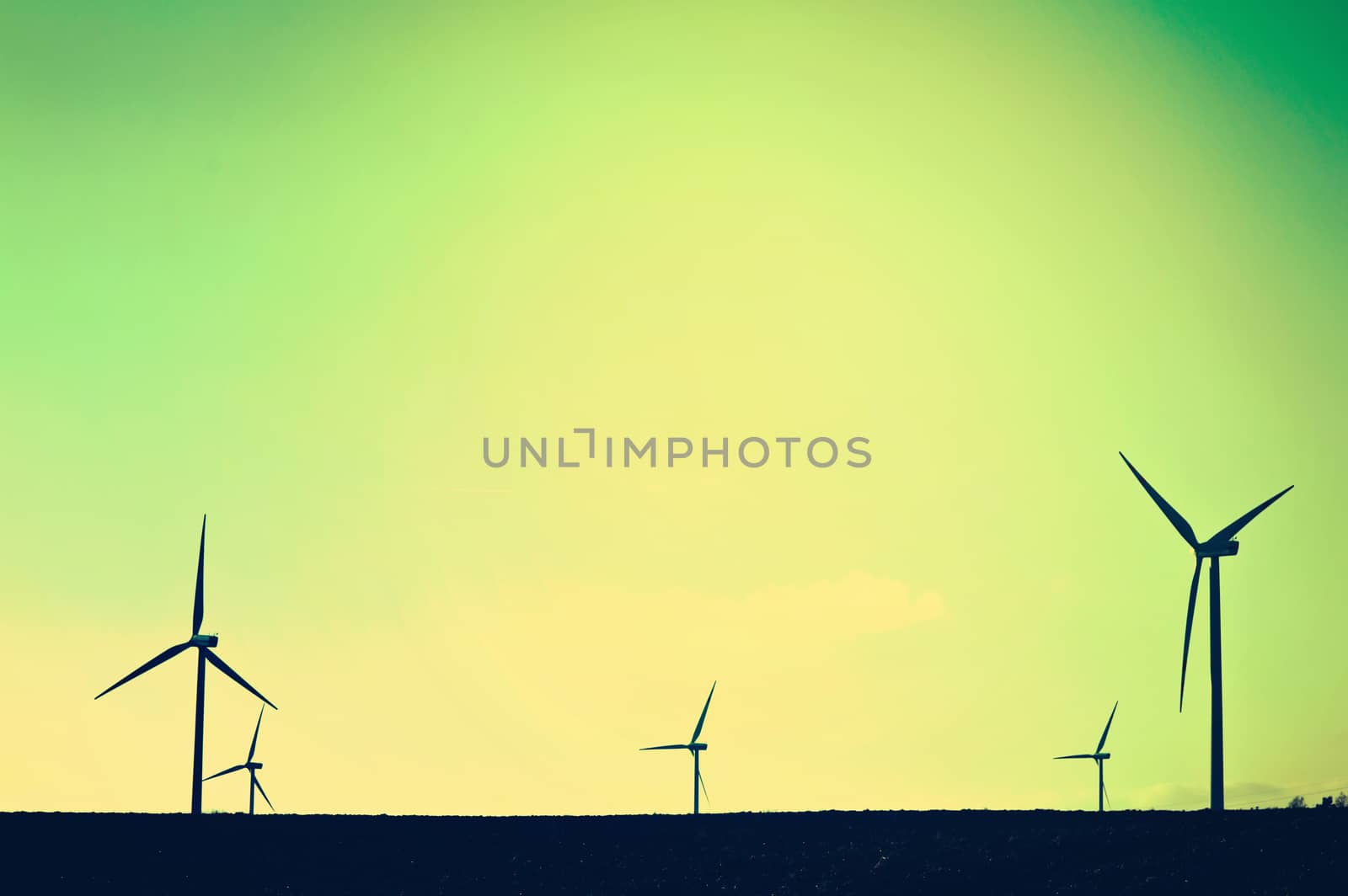 Shadows of windmills on the field. Vintage instagram picture. Alternative energy.