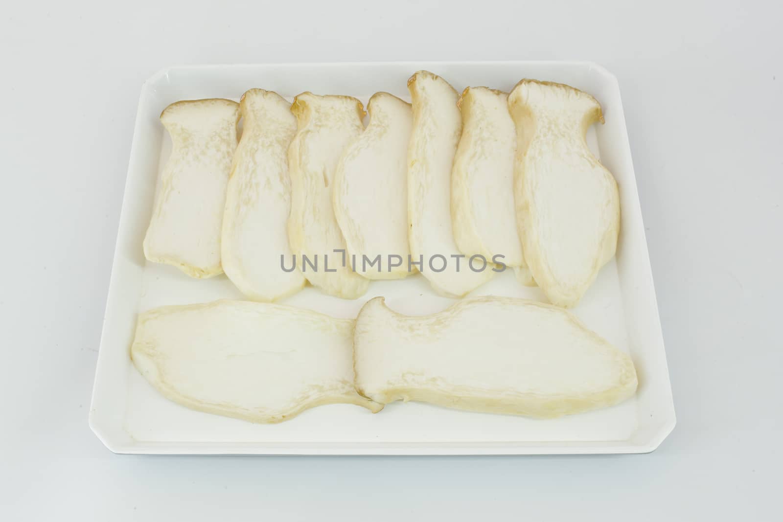 Eringii mushroom on white plate, isolated.