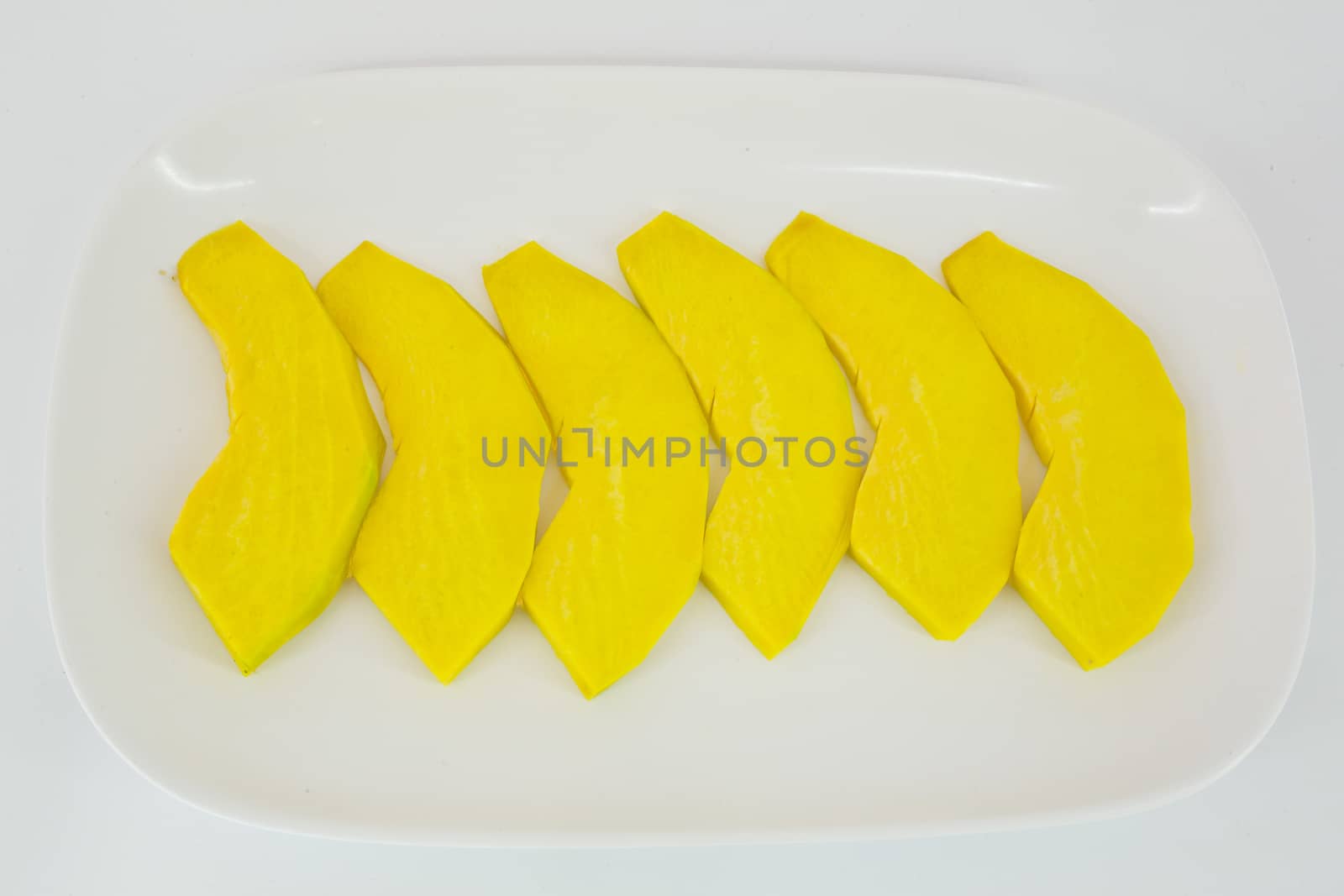 sliced pumpkin ready to be grilled isolate on white background