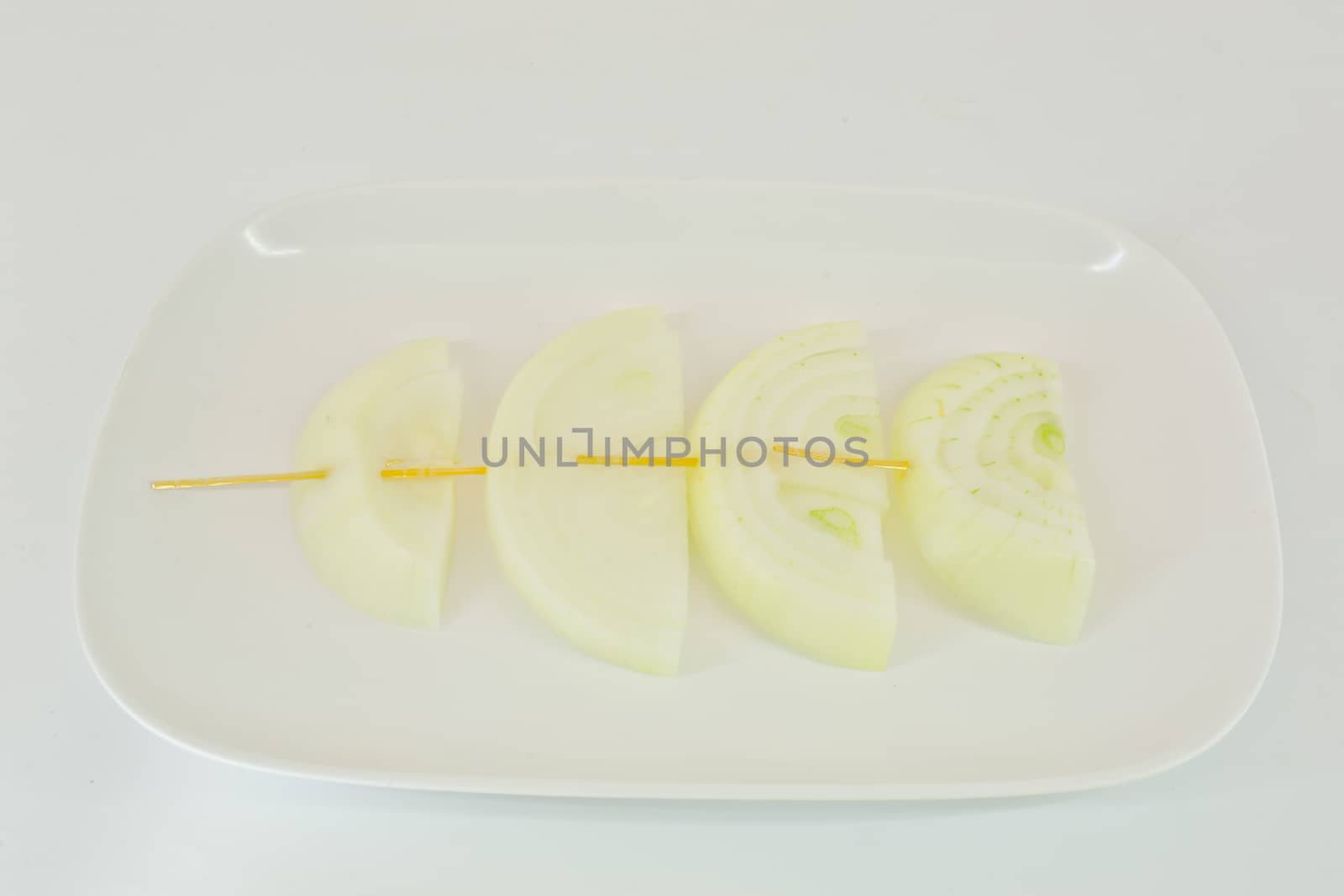 Skewers with fresh onions on the white plate - isolated