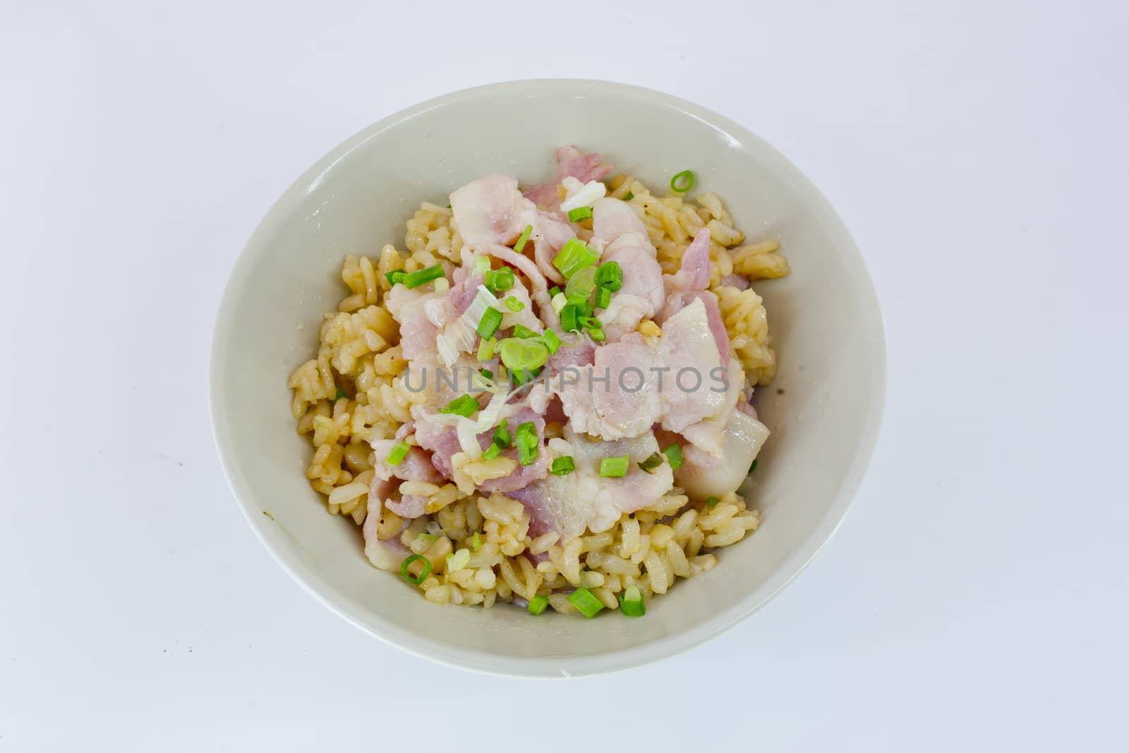 garlic fried rice with ham sliced and vegetable on top