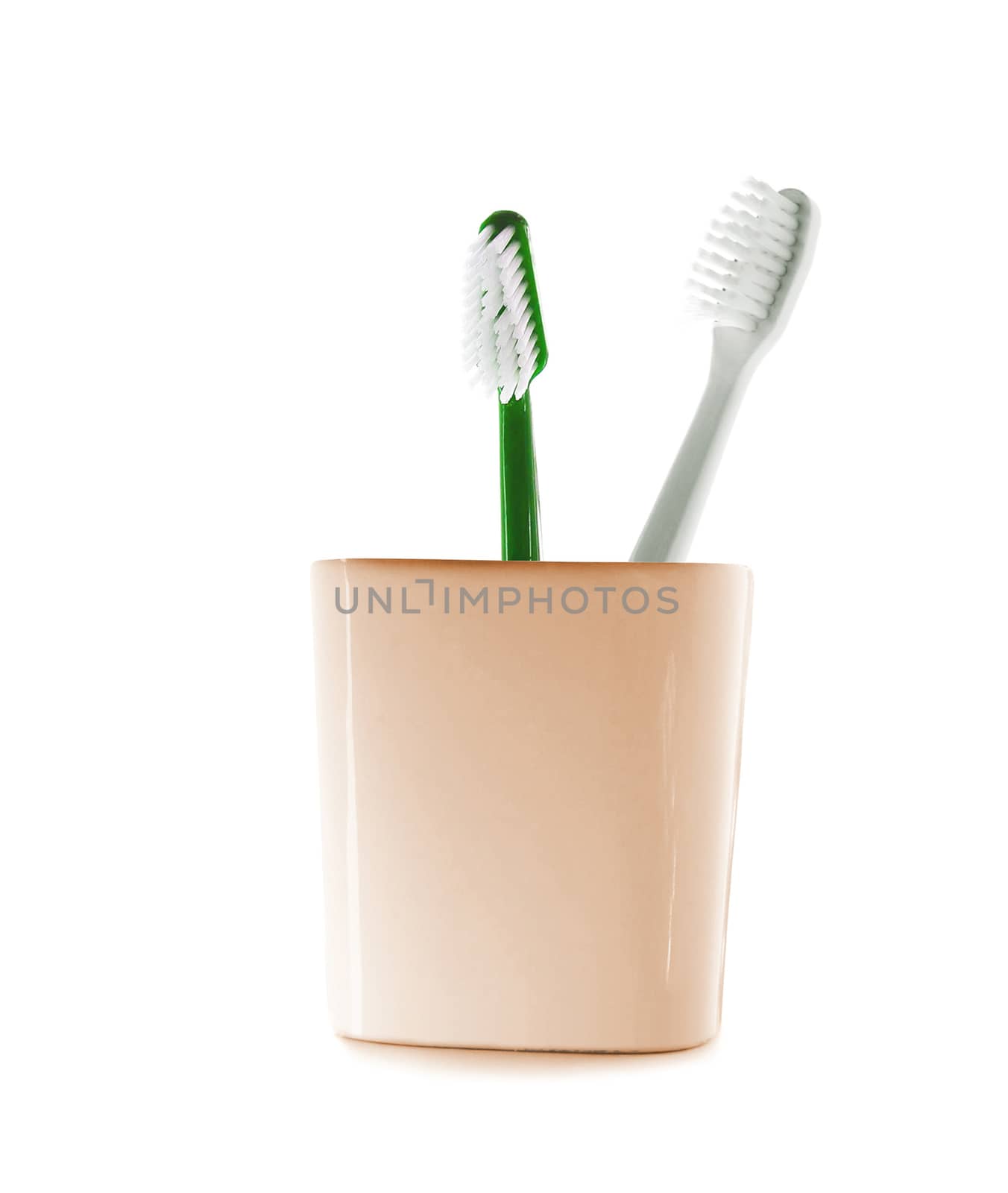 Two toothbrushes in glass