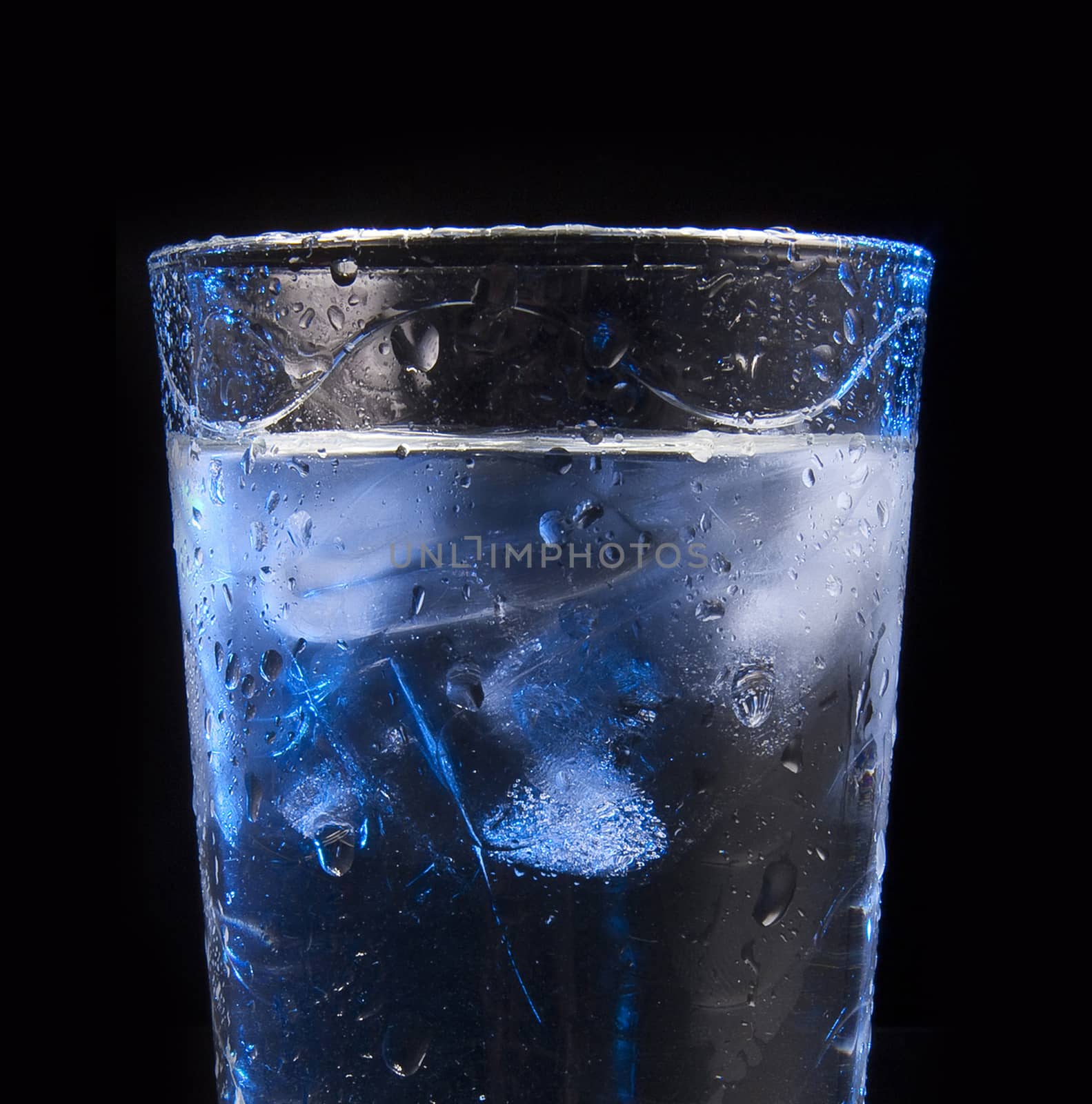 water in glass with ice cubes by ozaiachin