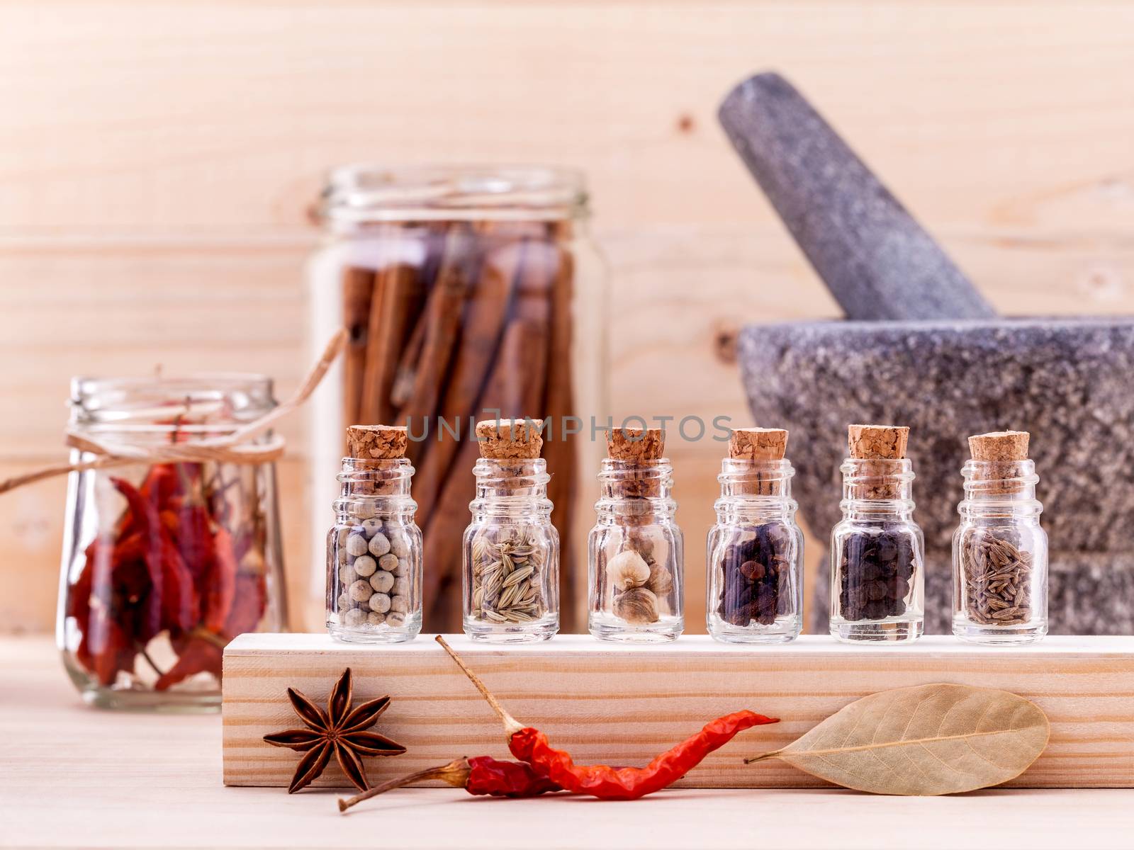 Assortment of Thai food Cooking ingredients in glass bottles on wooden background.