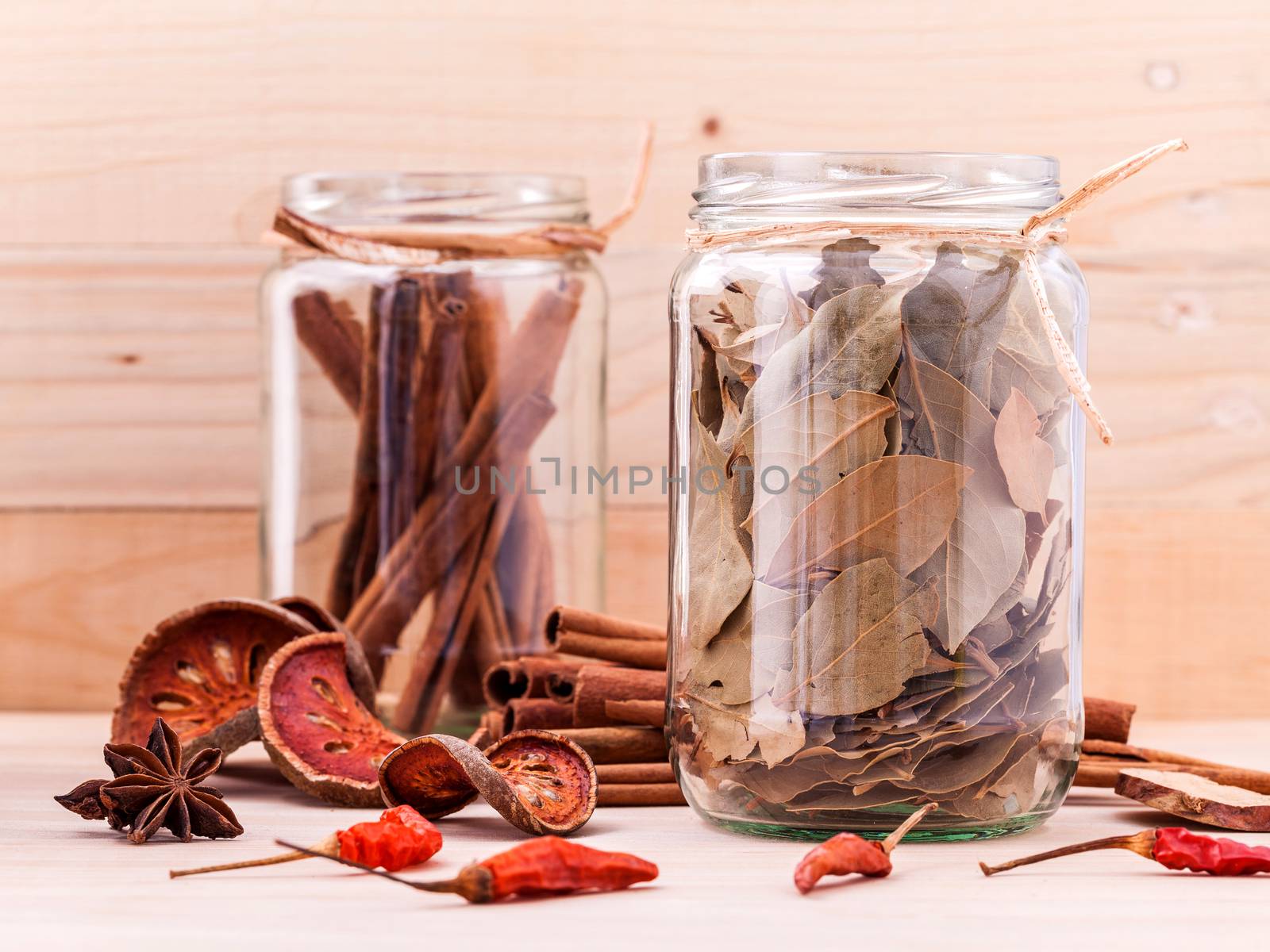 Assortment of Thai food Cooking ingredients in glass bottles on wooden background.