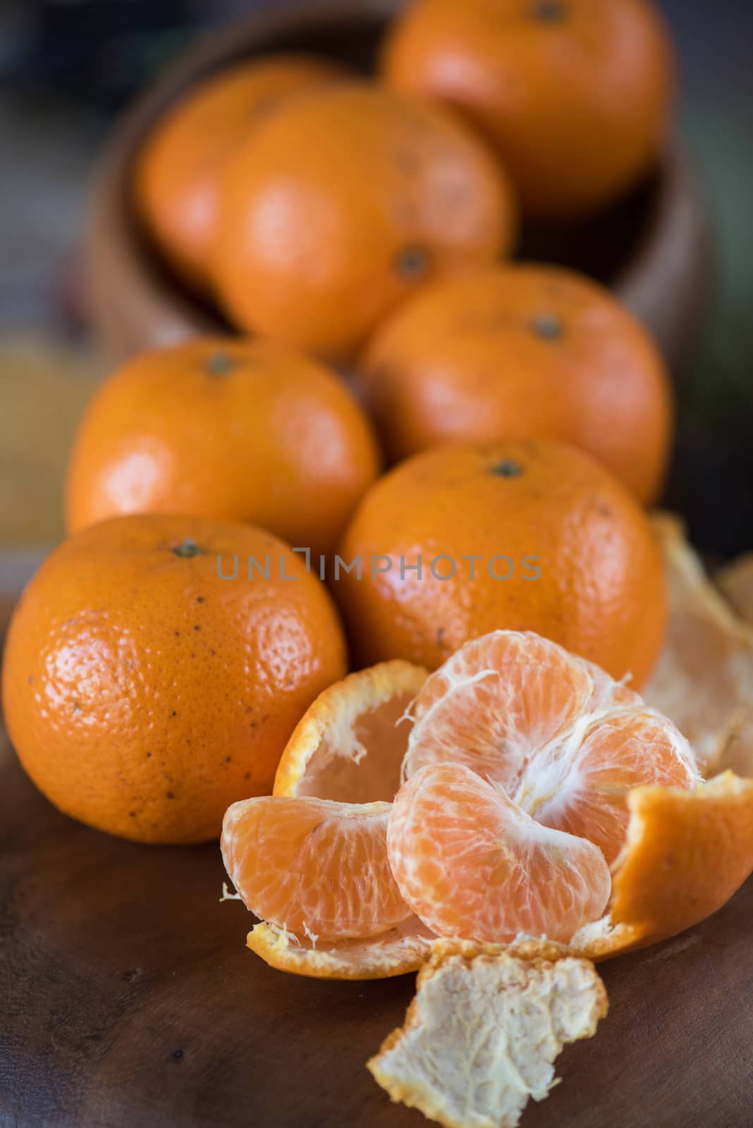 Ripe tangerines on wooden background