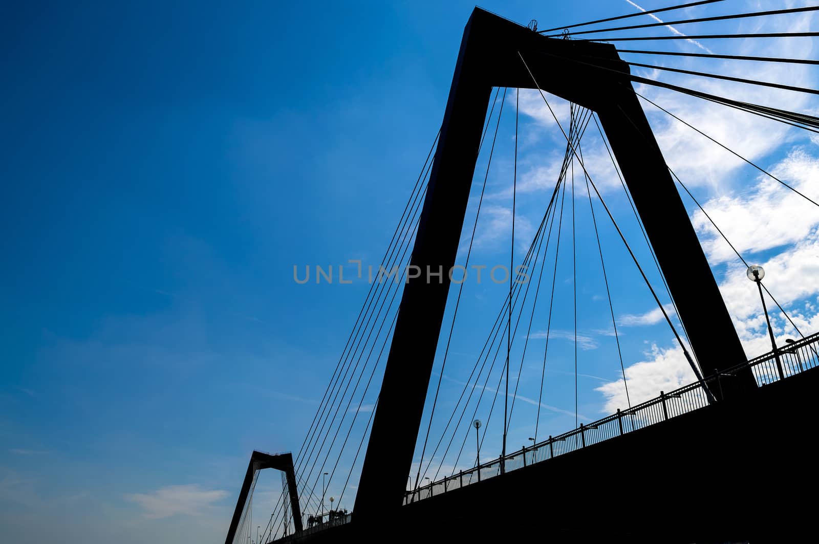 Rotterdam bridge silhouette in blue sky by rigamondis