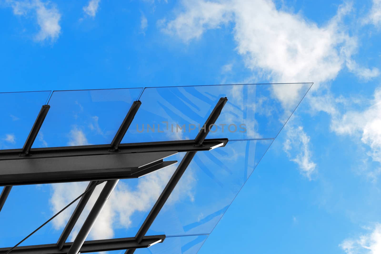 Detail of steel and glass roof of a modern building with blue sky and clouds