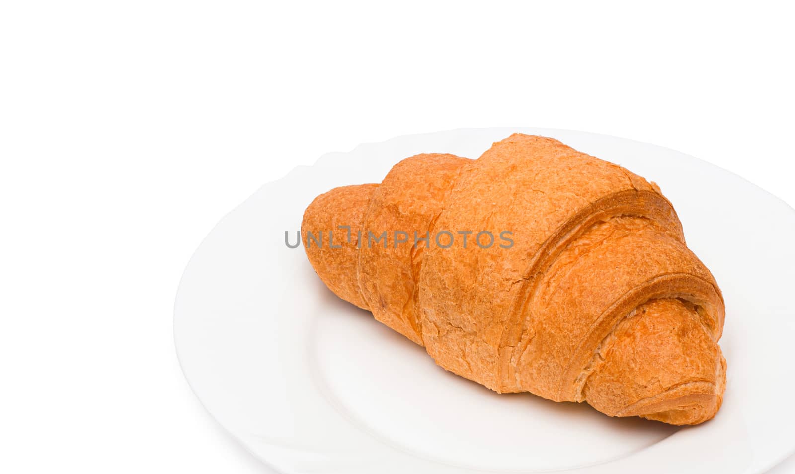 Fresh and tasty croissant over white background by ozaiachin