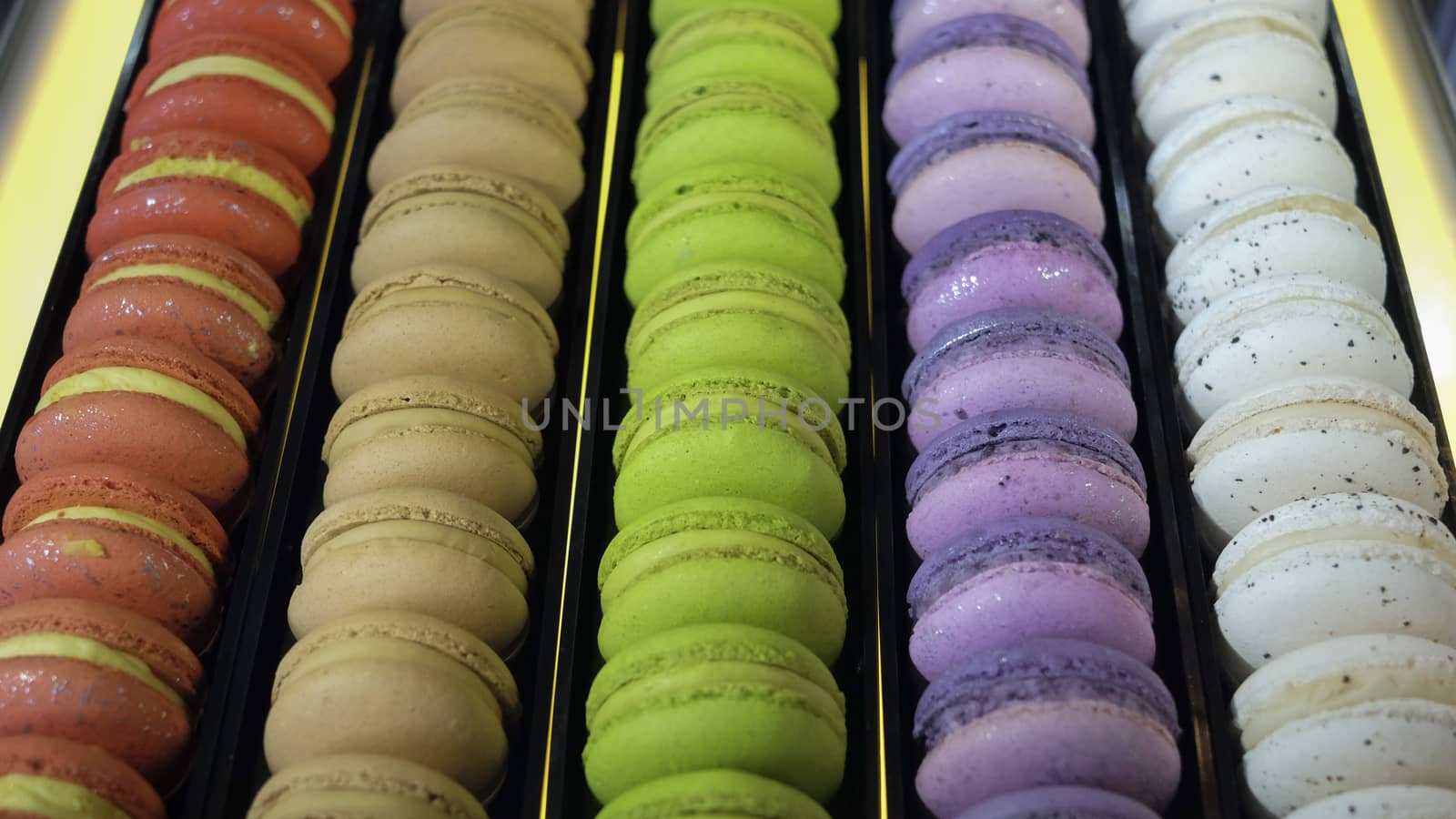 traditional french colorful macarons in a rows in a box