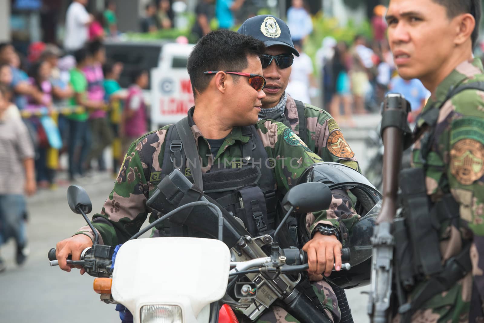 General Santos City, The Philippines - September 1, 2015: Armed police guarding the parade on the opening day of the 17th Annual Gensan Tuna Festival to celebrate the  most important industry of city, the tuna canneries.