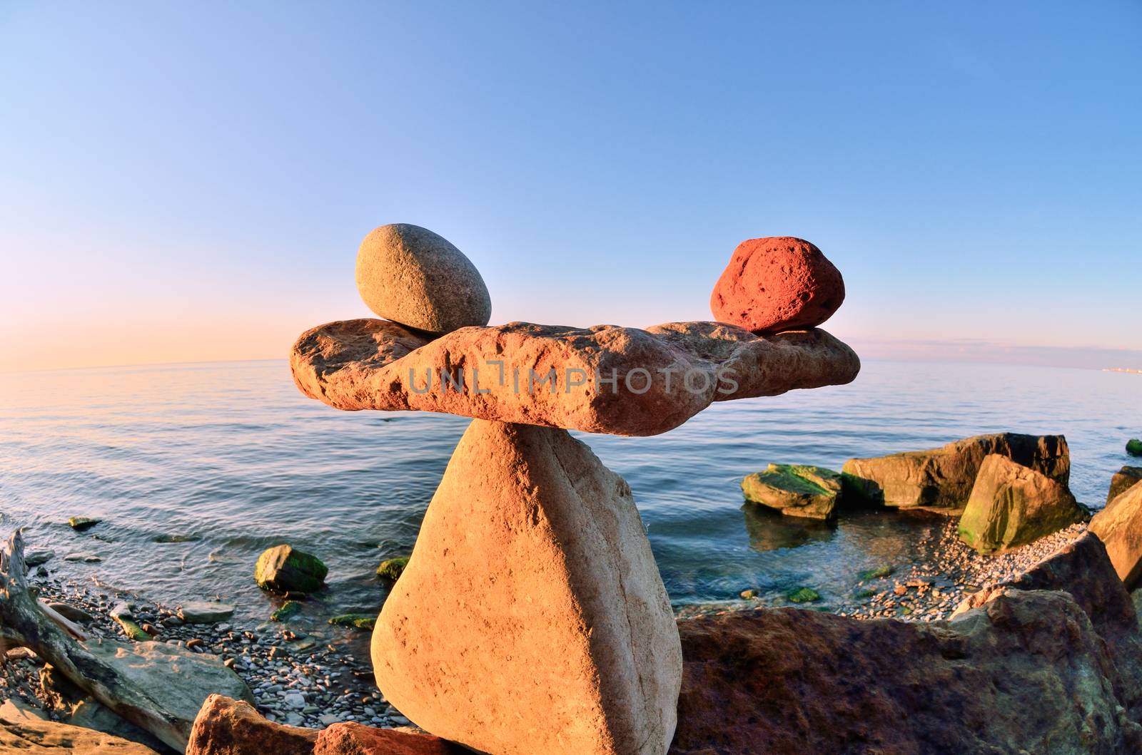 Symbol of scales is made of pebbles on the stony seashore