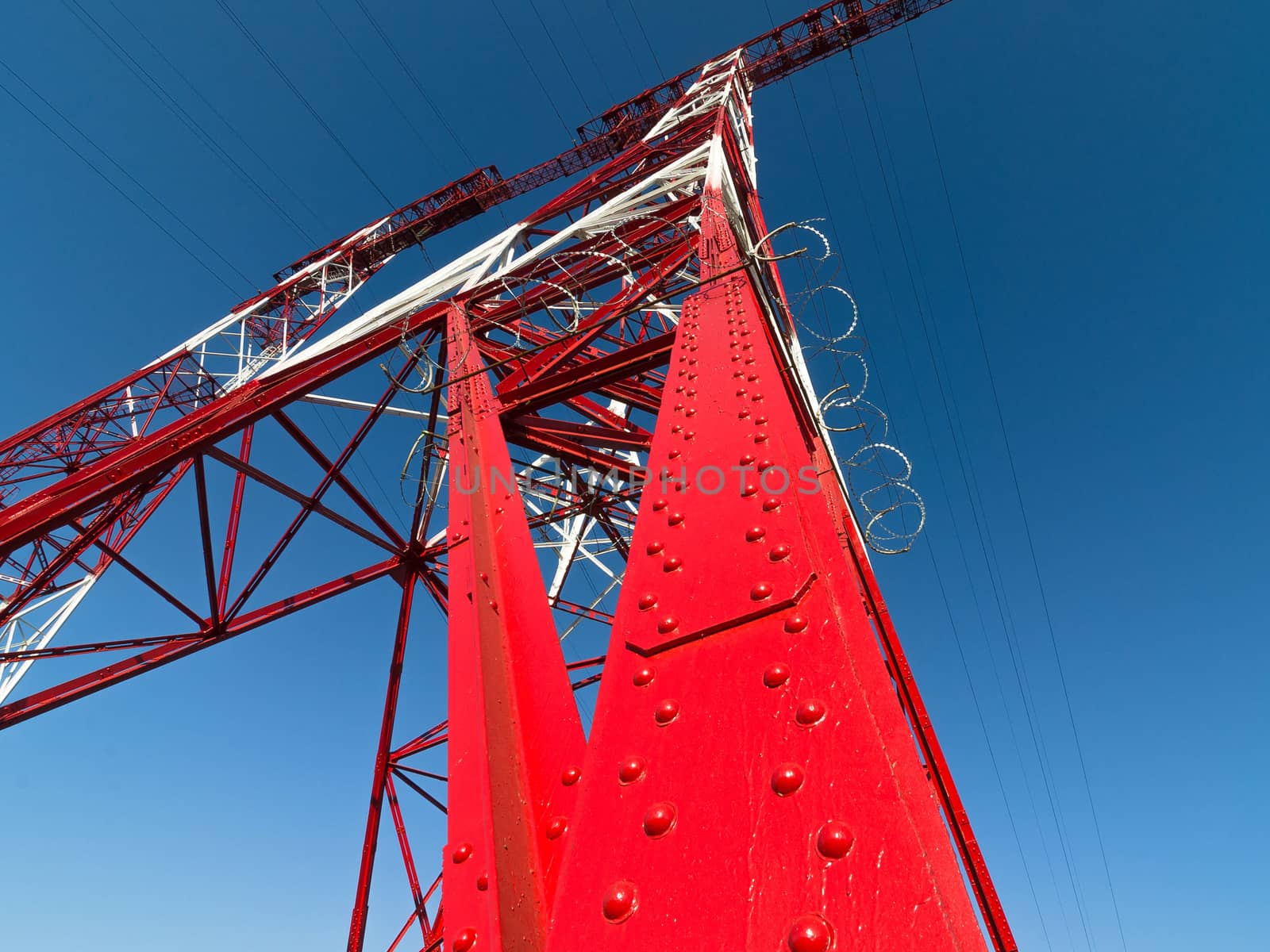 supports of high-voltage power lines against the blue sky