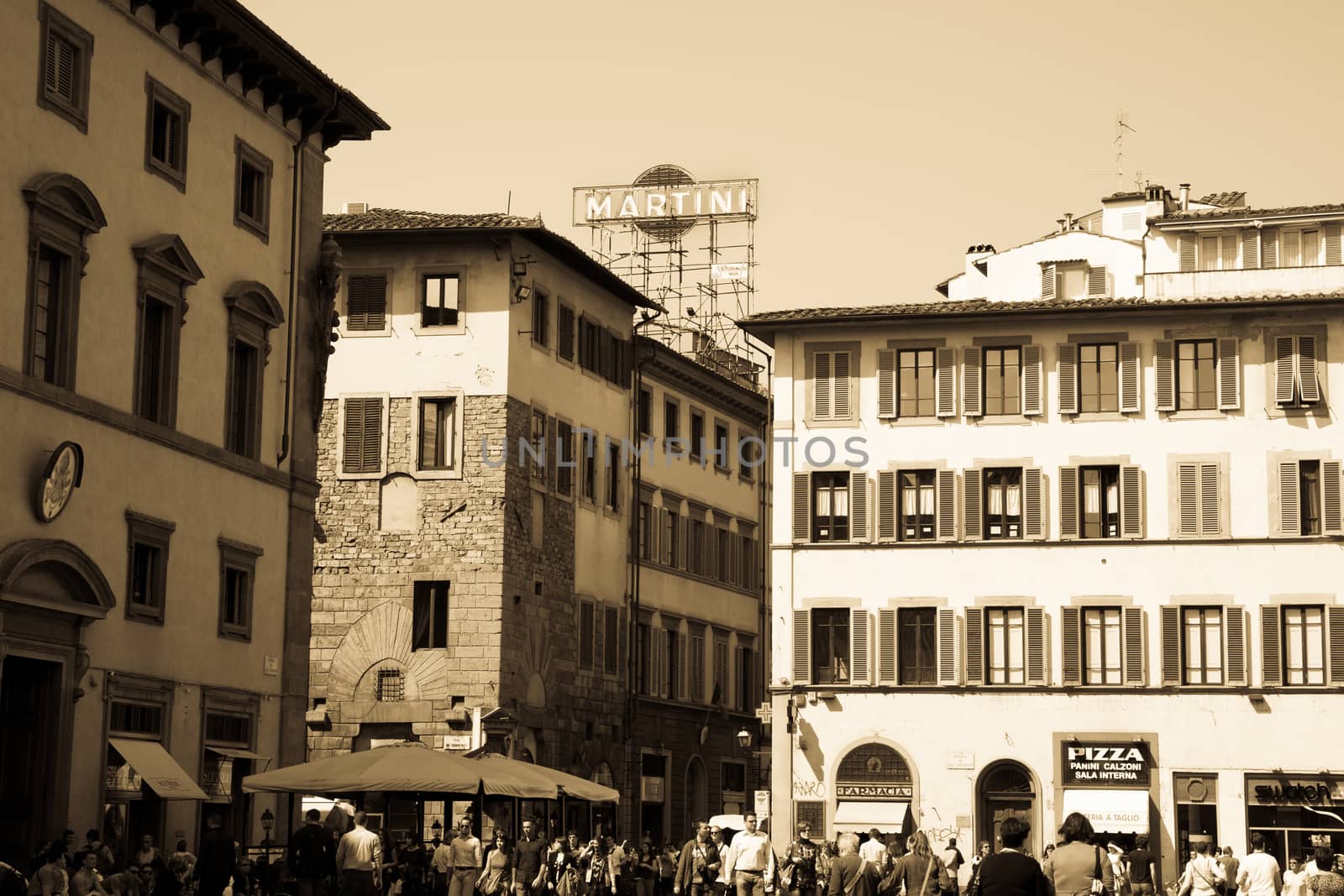 Florence, Italy- April 21;: Florence, Italy as it would have been, people going about their day crowd the street in bottom while typically Italian urban architecture and iconic signs complete the picture.