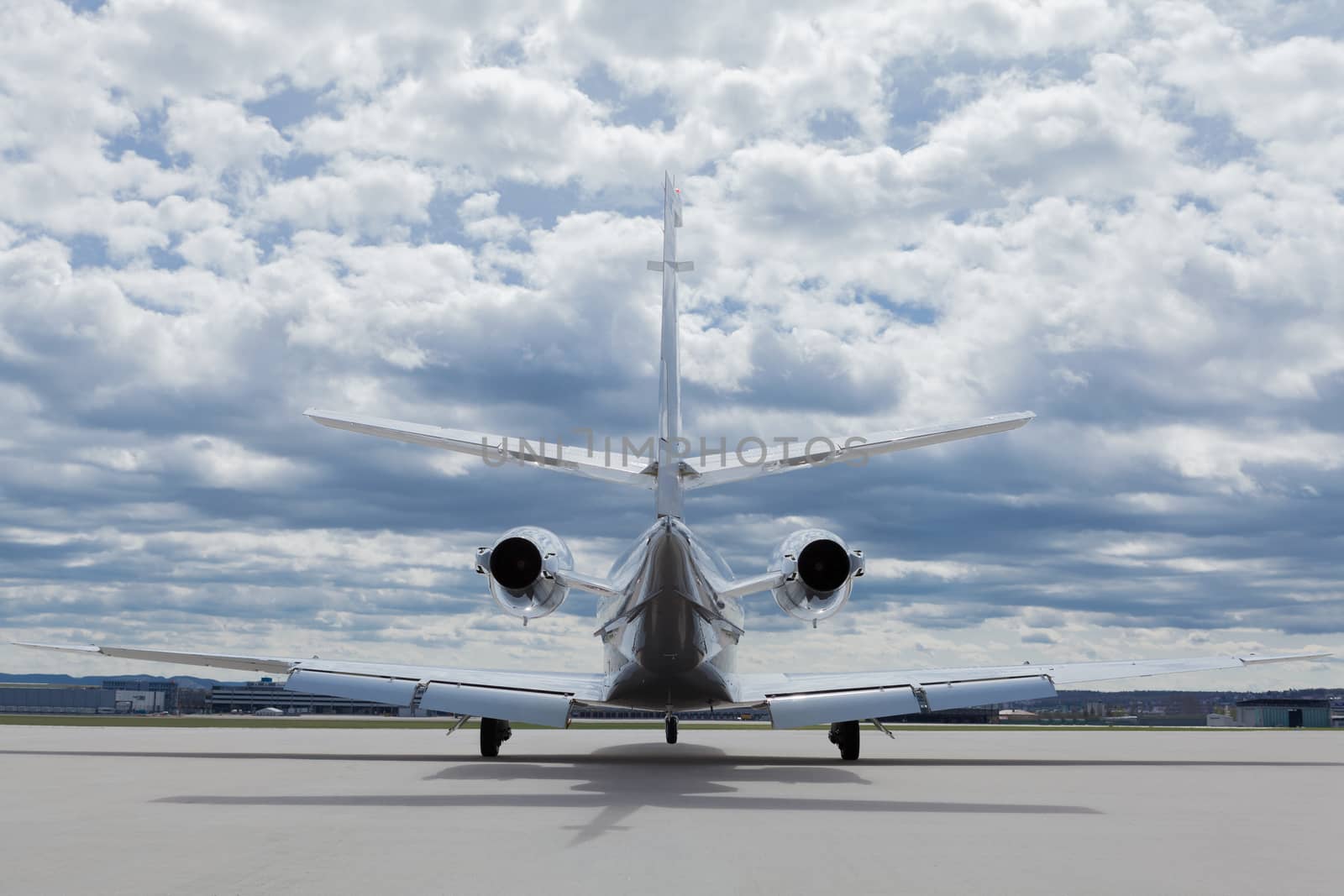 Aircraft learjet Plane in front of the Airport with cloudy sky by juniart