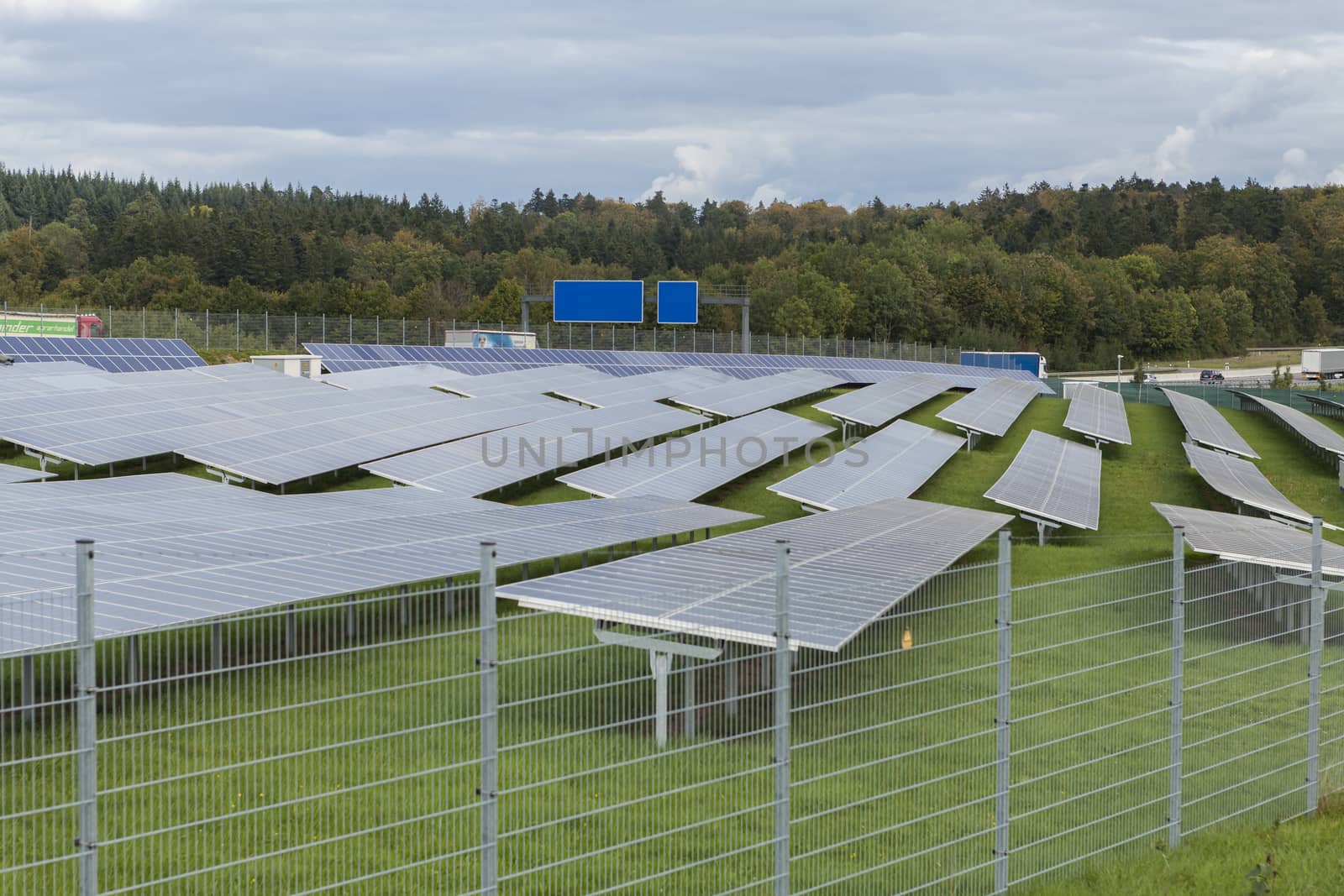 Field with blue siliciom solar cells alternative energy by juniart