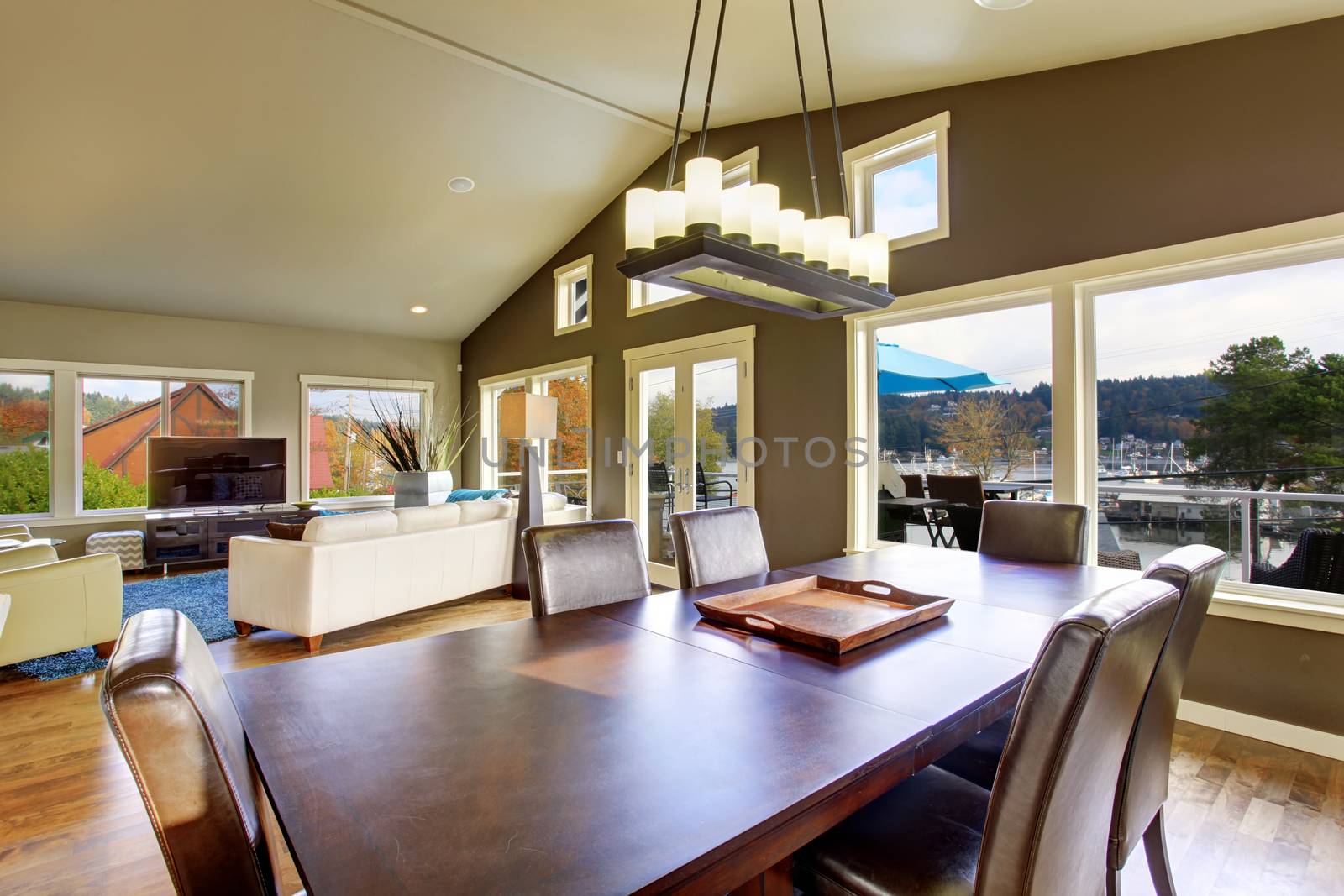Beautiful bright furnished dinning room with windows and wooden floor.