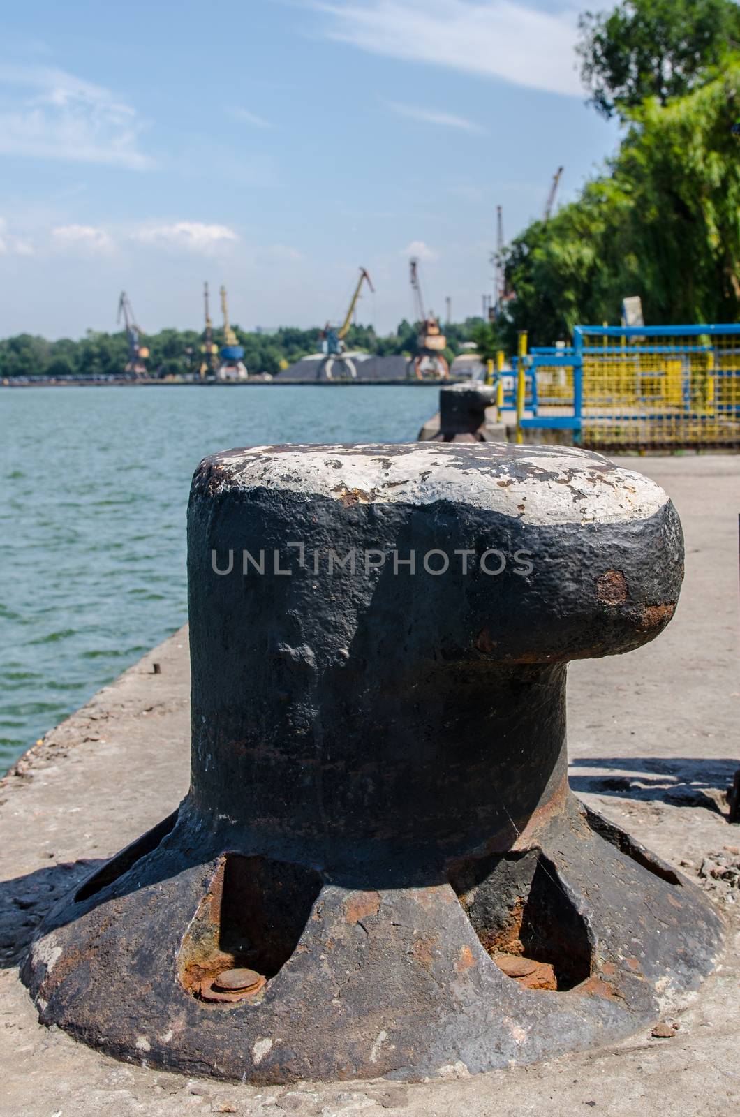 river port and cargo port with port cranes on a blue sky background