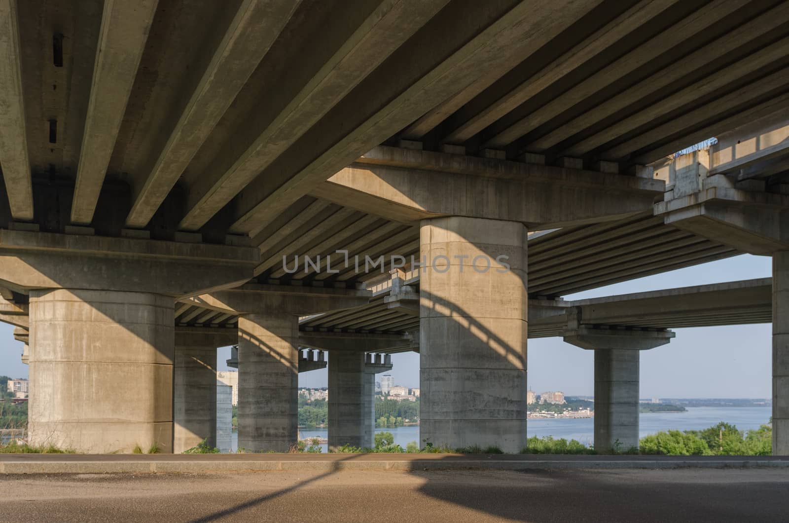 the construction of a bridge across the river with the supports, structural elements, cranes