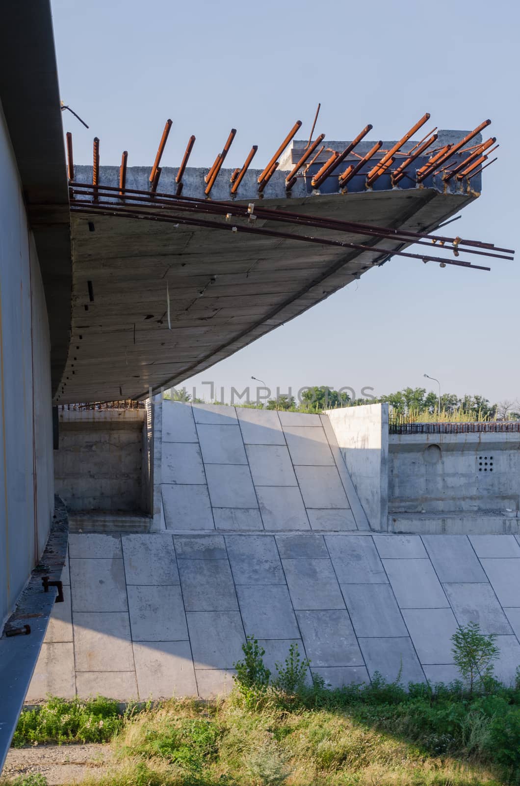 the construction of a bridge across the river with the supports, structural elements, cranes