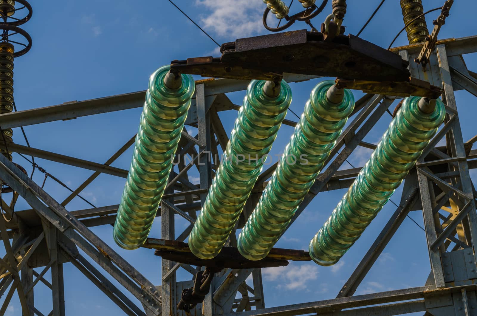 supports of high-voltage power lines against the blue sky