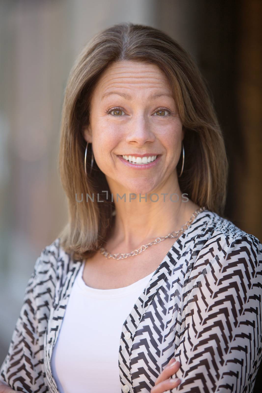 Beautiful single Caucasian woman outdoors with hopeful expression