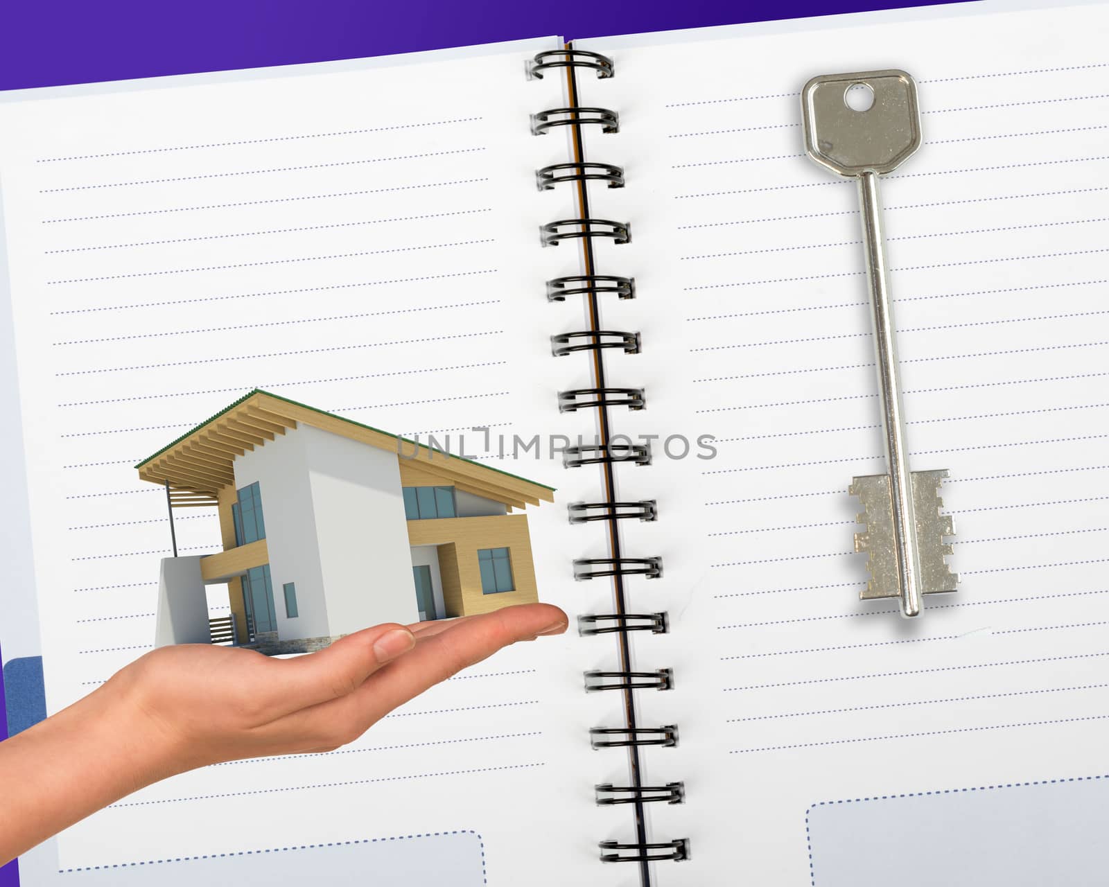 Humans hand holding house with key and notebook