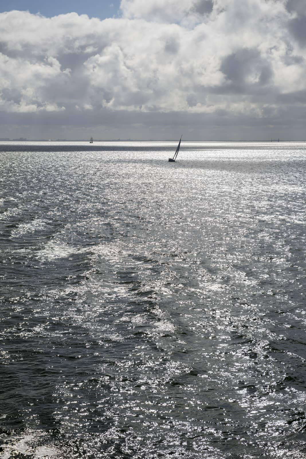 Sun over the Wadden Sea with sailing boat
 by Tofotografie