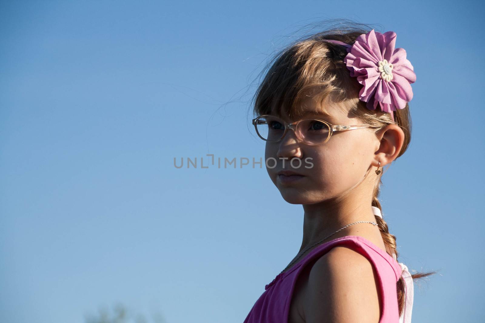  little blond girl with glasses bent her head