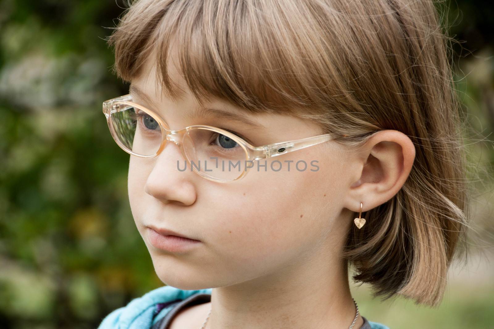little blond girl with glasses bent her head