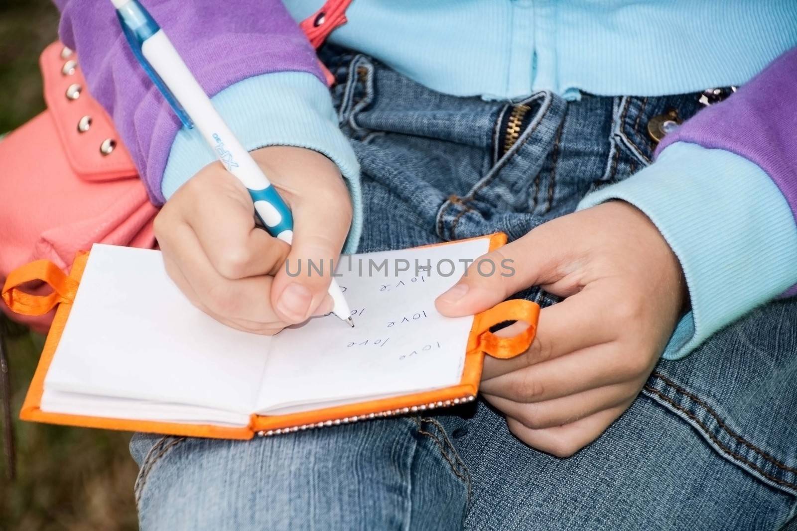 Clouse-up of girl hands writing in notebook