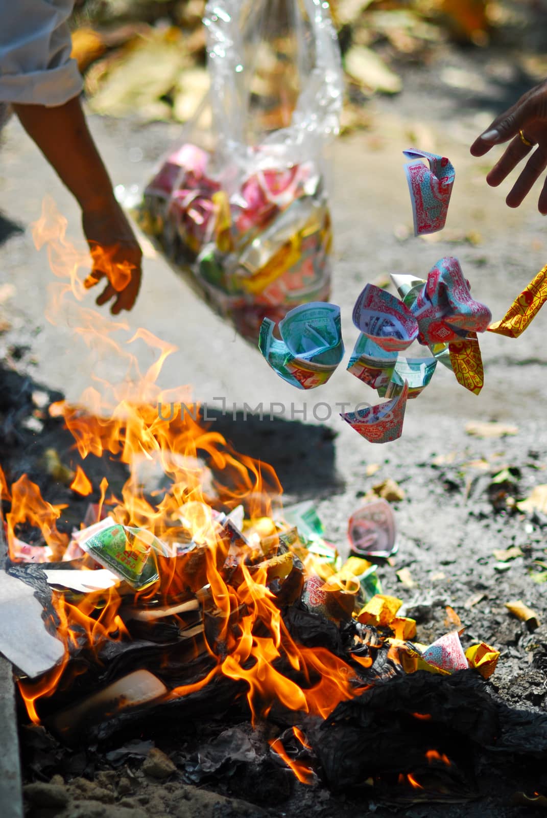 chinese people fire the forge money paper for die ancestor festival