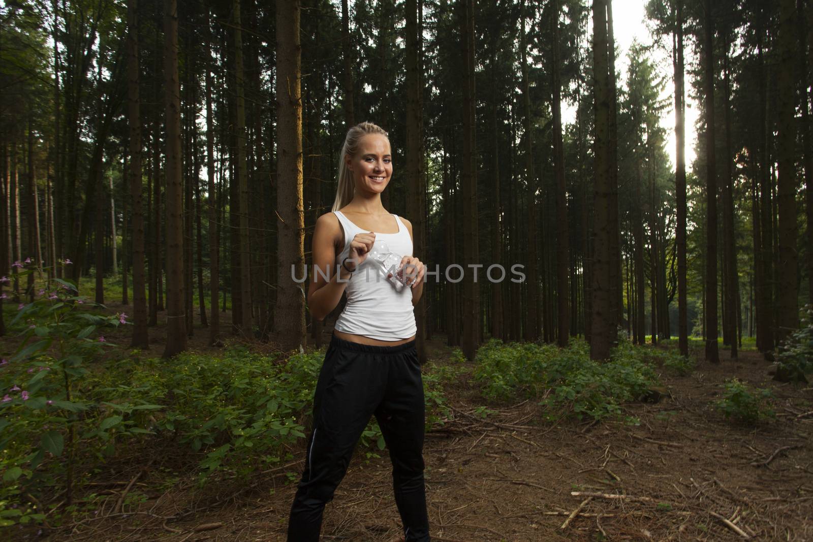 young female jogger with a water bottle by bernjuer