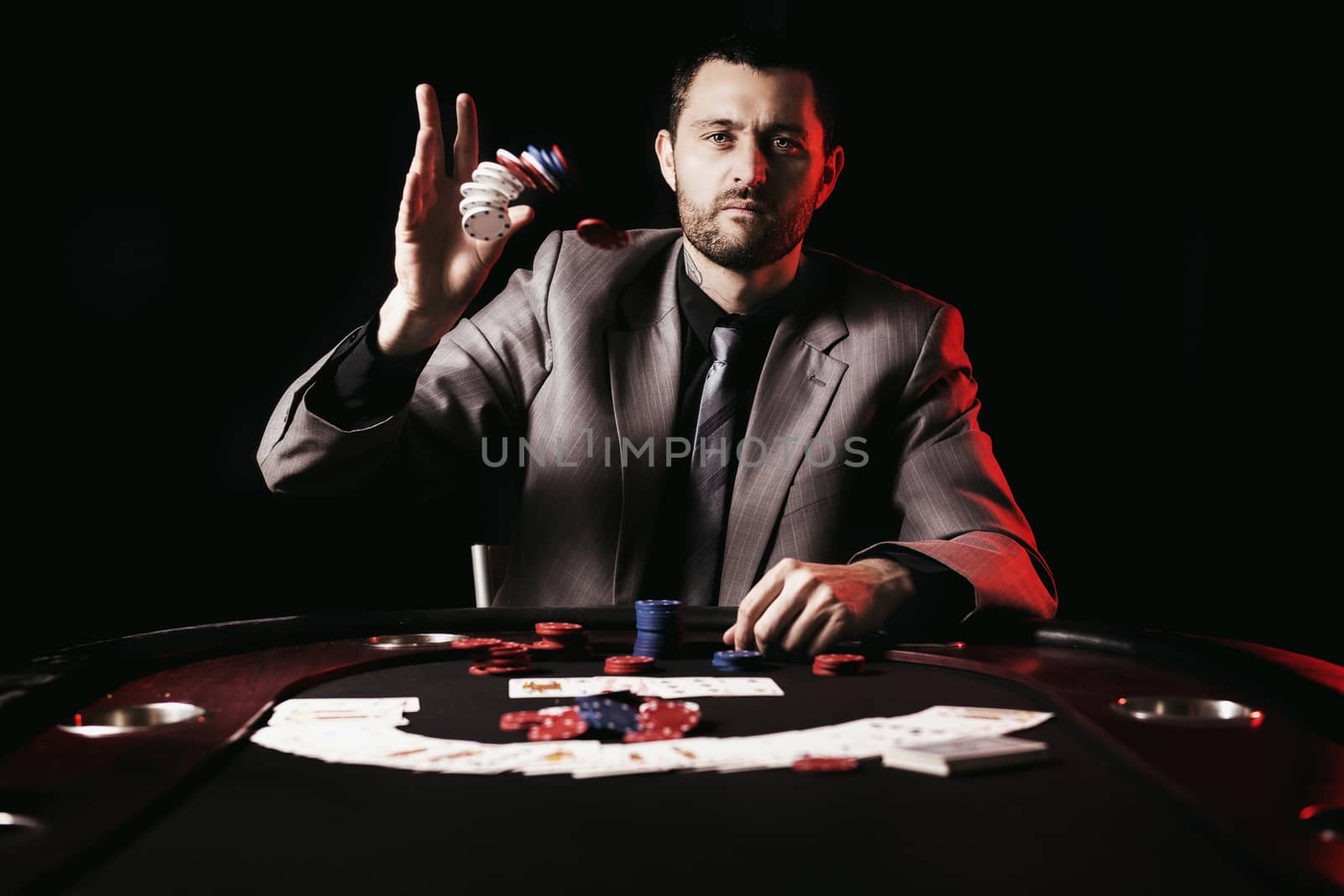 Concept: A high stakes poker player is frustrated and emotional over loosing and finding it hard to contain his emotions. Cinematic portrait.