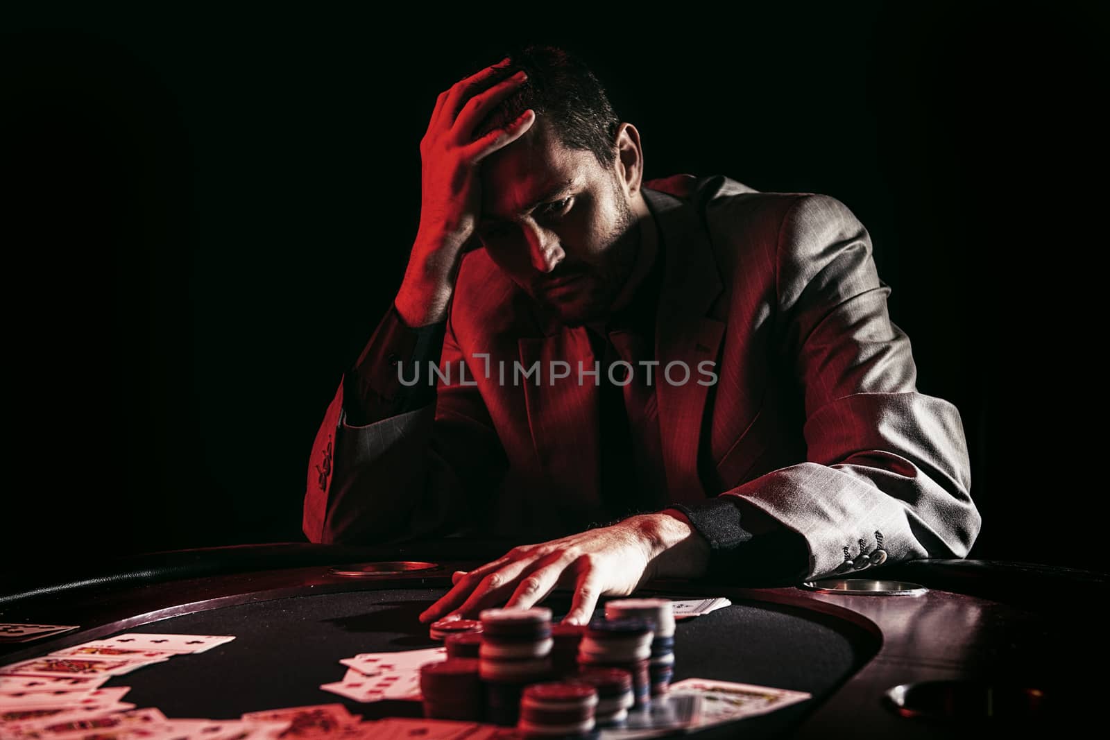Concept: A high stakes poker player is frustrated and emotional over loosing and finding it hard to contain his emotions. Cinematic portrait.