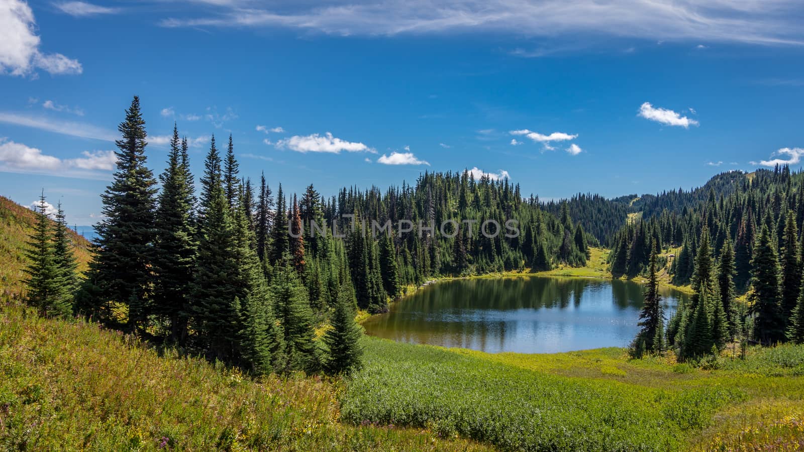 Tod Lake under a beautiful sky on a hike to the summit of Tod Mountain in the Sushwap Highlands of central British Columbia, Canada. The lake is located at an elevation of about 6000 feet