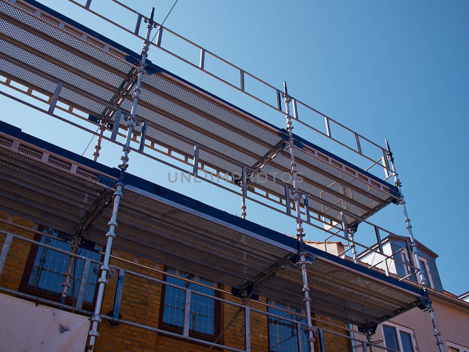 Modern sophisticated scaffolds on a house building under extensive renovations