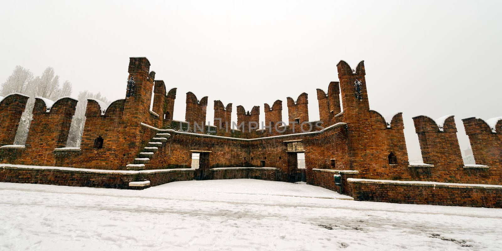 Ancient Scaligero bridge in winter when it is snowing - Verona (UNESCO world heritage site) - Veneto, Italy