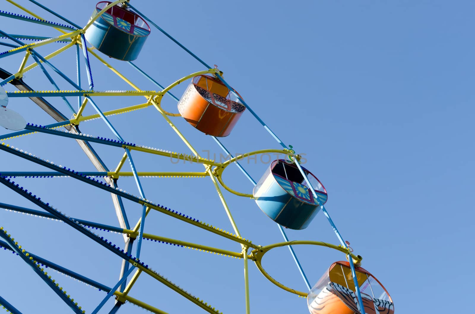 Ferris wheel on the background of blue sky